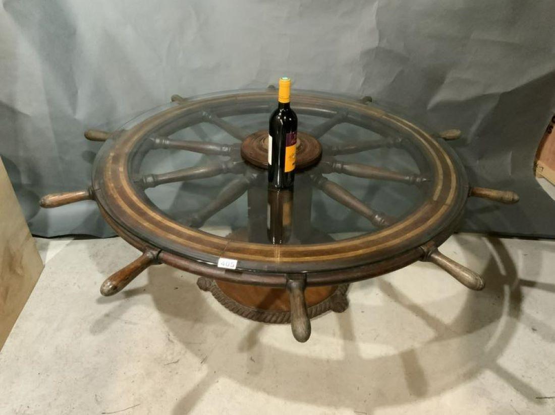 Mahogany ship's wheel from the late 1800's made into a table long ago, with rope carved wood base fitted with a glass top.

Overall dimensions: 57