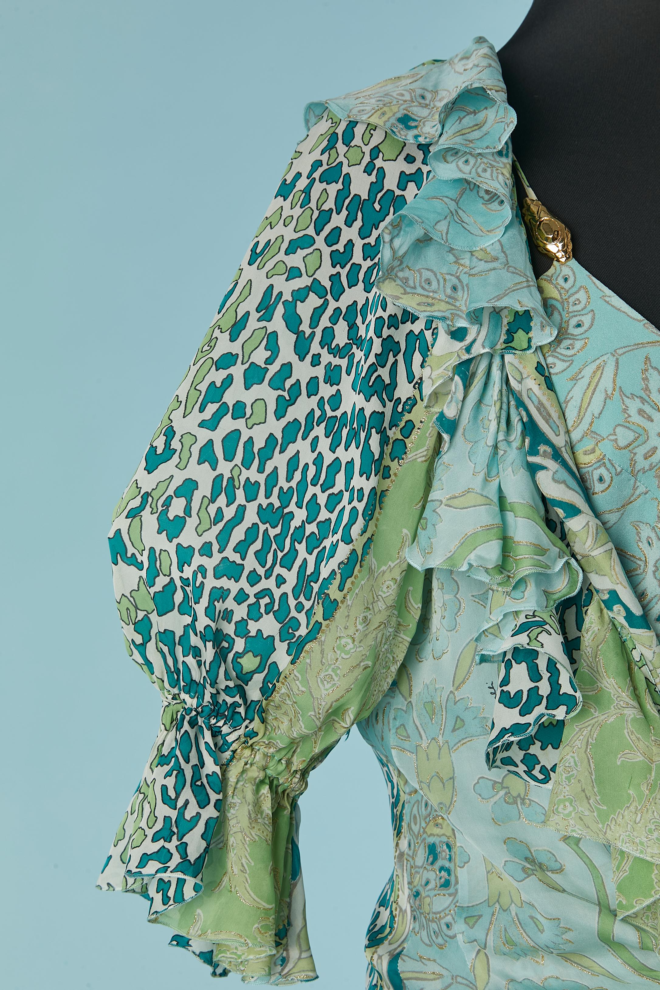 Shirt and dress ensemble in printed and branded silk. The shirt is in silk chiffon and the dress in 3 weight of silk. Transparent plastic snap closure on the middle front. Elastic band on the sleeves with ruffles edge. Ruffles on the neckline as