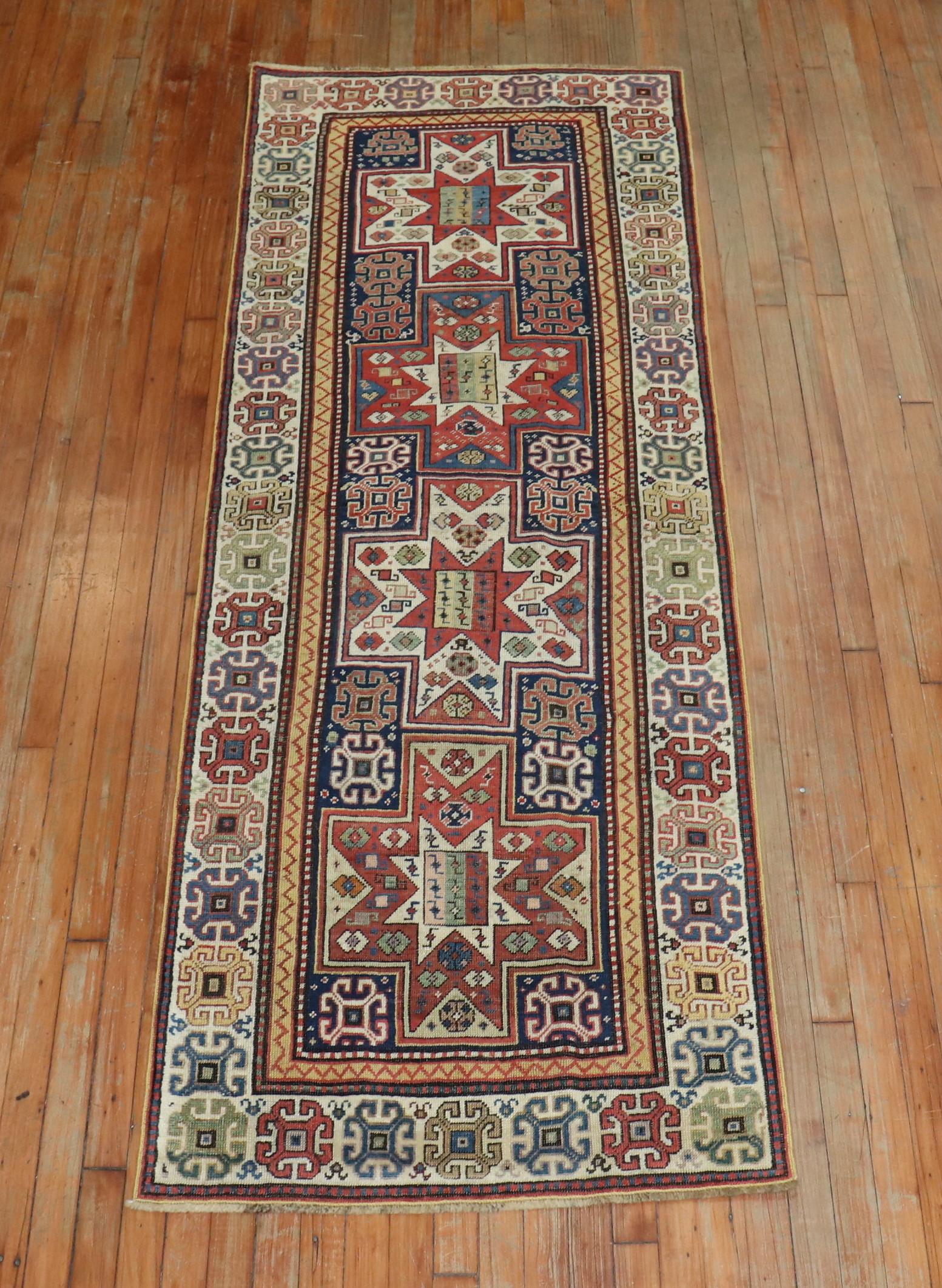 An early 20th century Caucasian Shirvan Runner. Rust, ivory red dominant accents on a navy ground.

Measures: 2'10