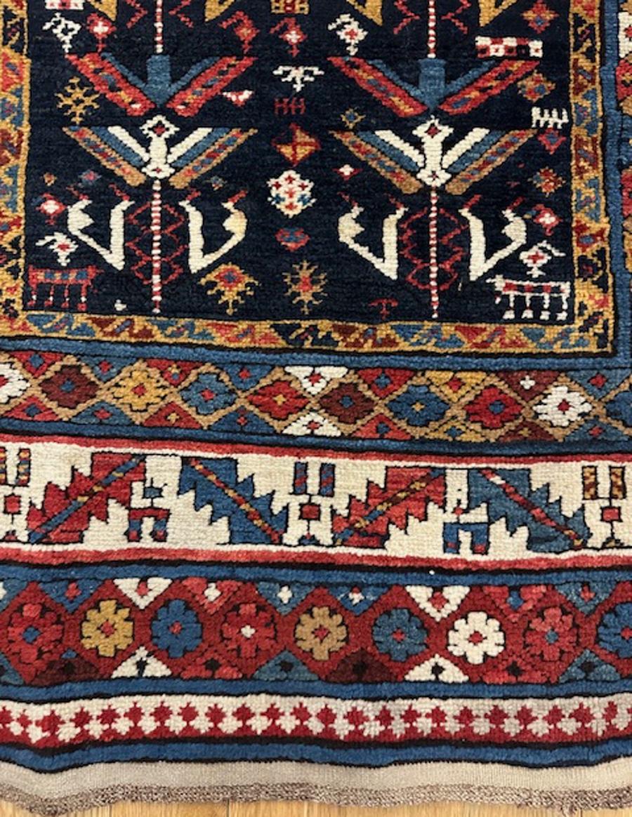 Schirwan Langteppich aus dem östlichen Kaukasus, Westküste des Kaspischen Meeres

Alter: um 1880

Abmessungen: 8′.9″X3′.9″ (267×114 cm)

Das navy Feld beschäftigt zwei Spalten von aufsteigenden stilisierten Blumen in Elfenbein, Kamel, gelb, rot und