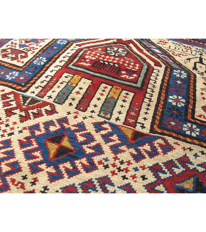 Shirvan Prayer Rug, 19th century

Diagonal rows of multi-colored latch-hook diamonds stripe across the ivory field of this classic Caucasian Shirvan prayer rug from the Caspian region of Azerbaijan. In the style of folk weaving from the region, an