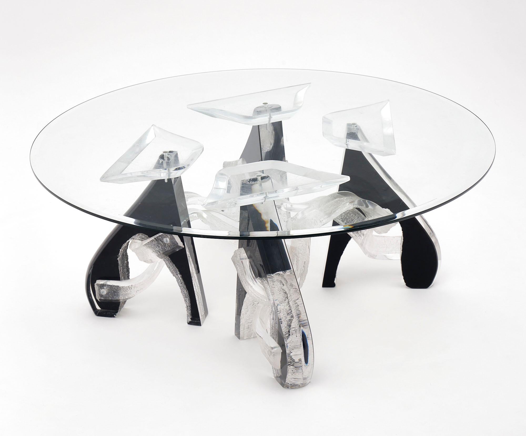 Coffee table made of clear and black Lucite with a glass top. This piece is in the style of artist Shlomi Haziza.
