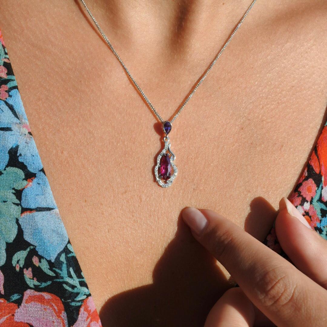 1.48 Carat GIA Certified Natural Sapphire Diamond Pendant 18K White Gold

A classic.
This remarkable two-stone red and purple sapphire pendant is done in a classic design, surrounded by a swirling halo of brilliant cut diamonds on a delicate Italian