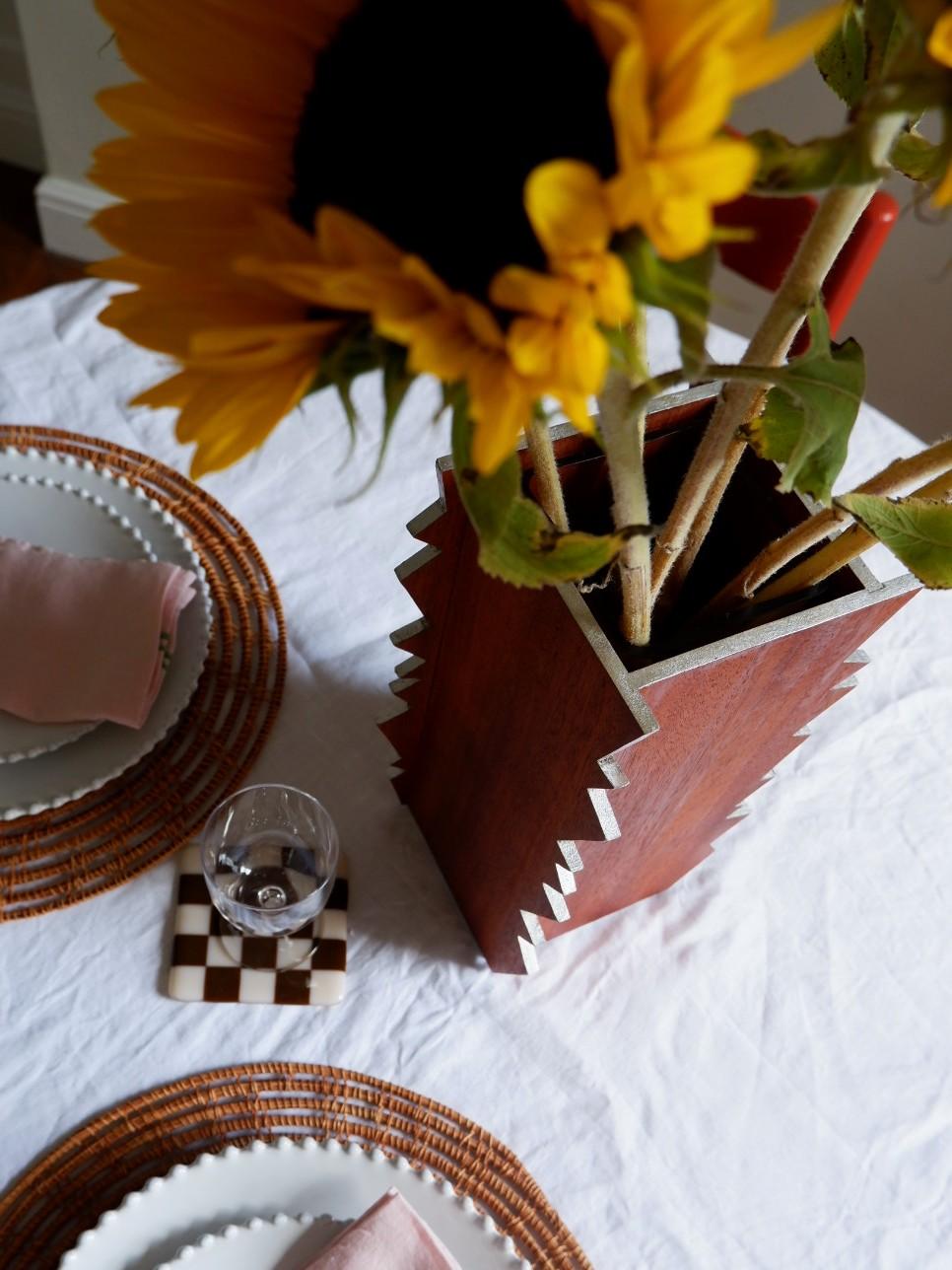 The Shocking Vase. A contrasting sharp, modern look to work with your organic arrangements. Designed to add a bit of drama to your table top.

Made from Sapele and edges oil gilded with Aluminium. Each Vase is supplied with a water tight glass