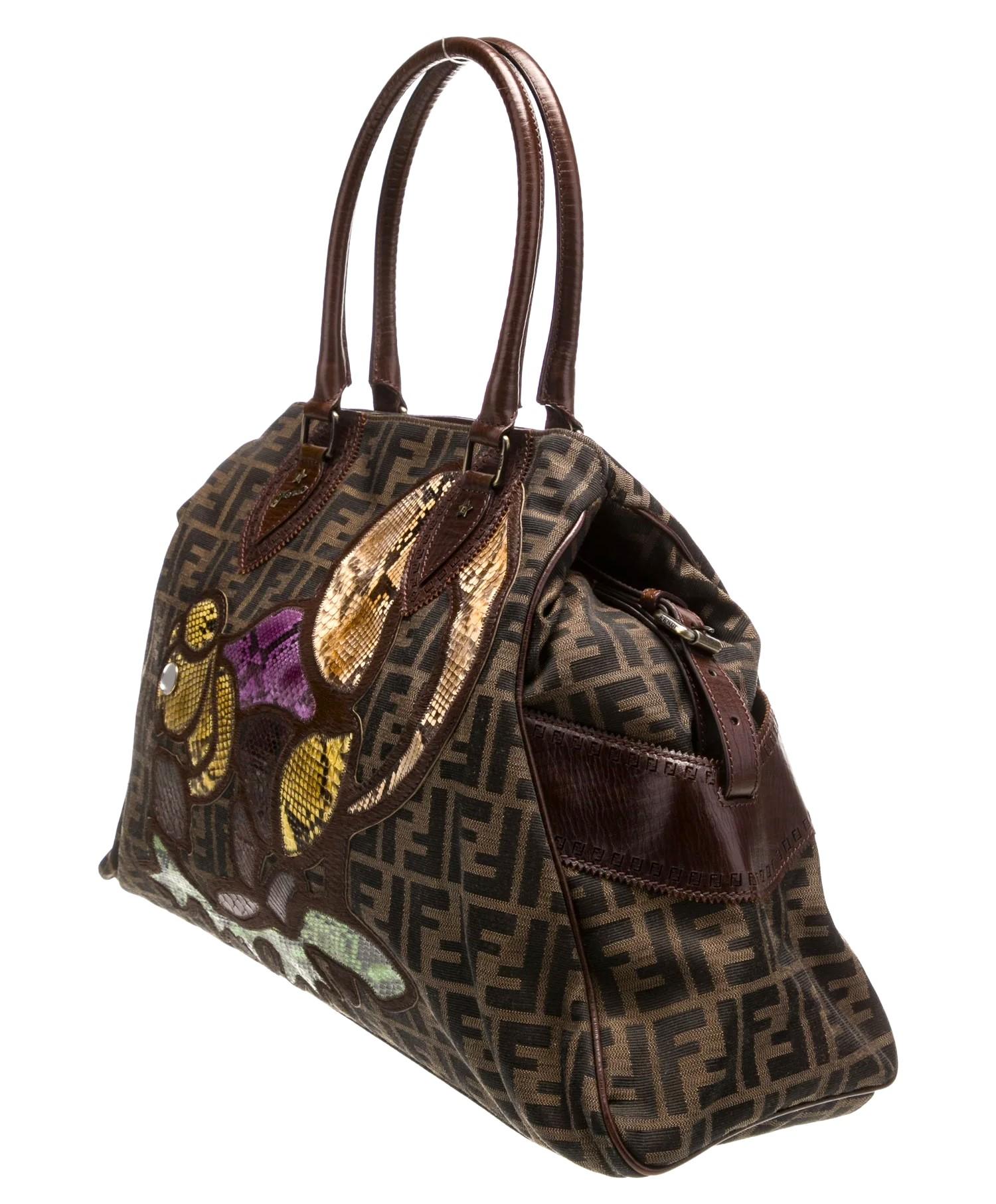 Karl Lagerfeld For Fendi 2007
New With Dust Cover
Oversized Zucca Du Jour Bag 
Classic Fendi Zucca Canvas
Python Applique' Squirrel motif 
Brass Hardware
Rolled Boar Leather Trim & Handles
Dual Exterior Pockets
Adjustable Side Buckles to extend to a