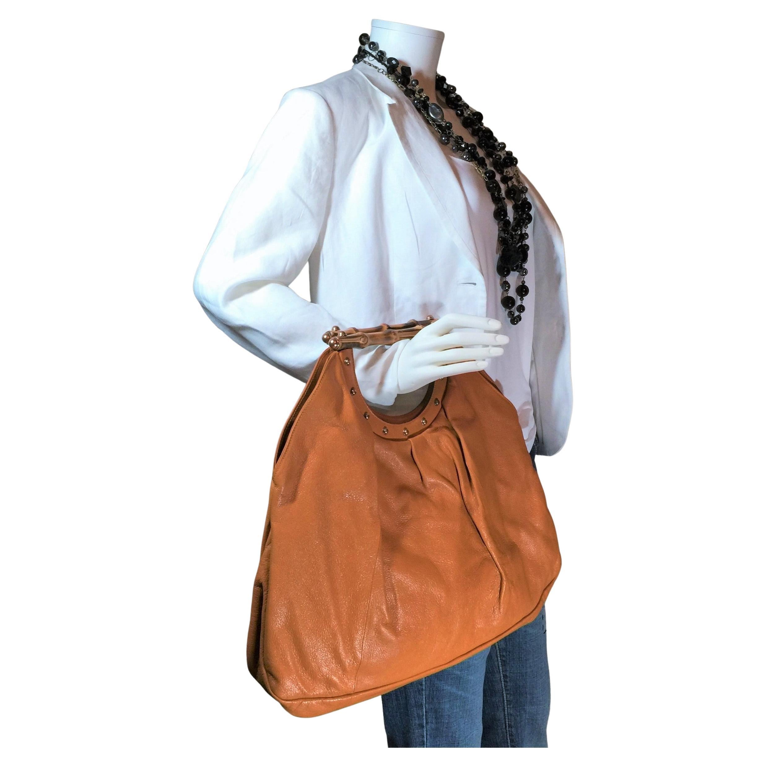 Shockingly New Tom Ford For Gucci Large Bamboo Leather Tote
With Dust Cover

Orange Napa Leather
Gold-Tone Hardware
Bamboo Handles
Studded Accents
Canvas Lining & Single Interior Pocket
Open Top

Handle Drop: 4