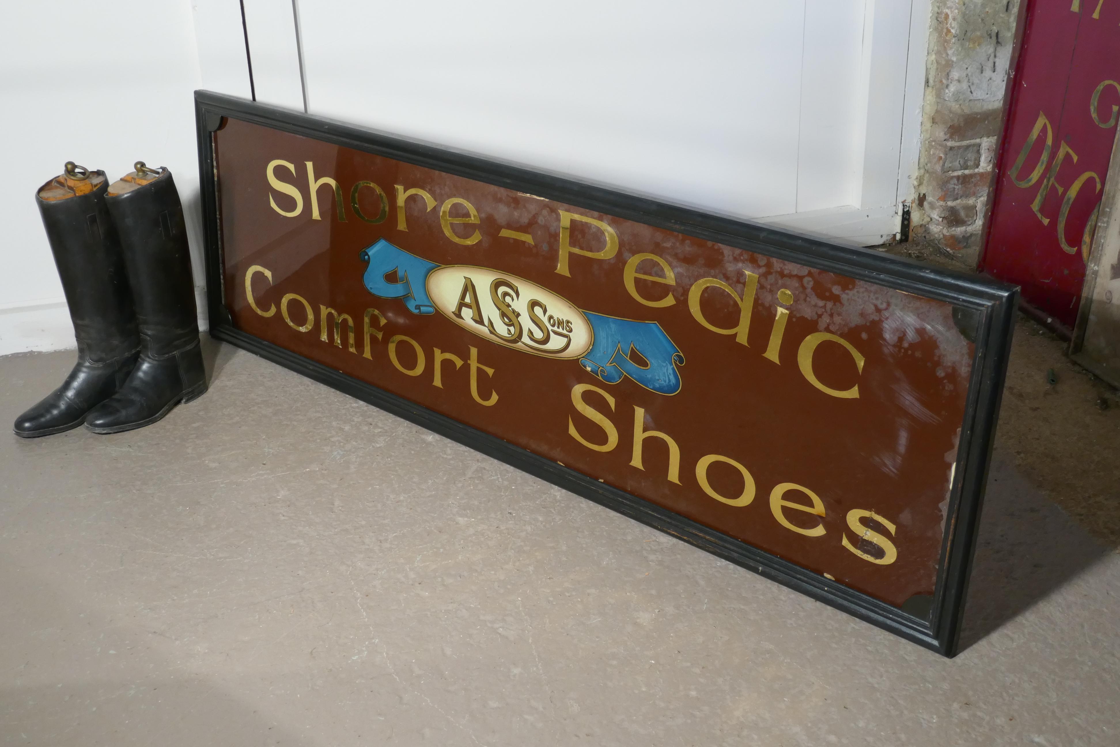 Shoe shop mirror advertising sign, A S & Sons Shore Pedic Shoes.

This is a great and authentic piece, the sign has gold mirrored lettering on brown glass, the glass is set in a black frame and is advertising, Shore Pedic Comfort Shoes
The sign