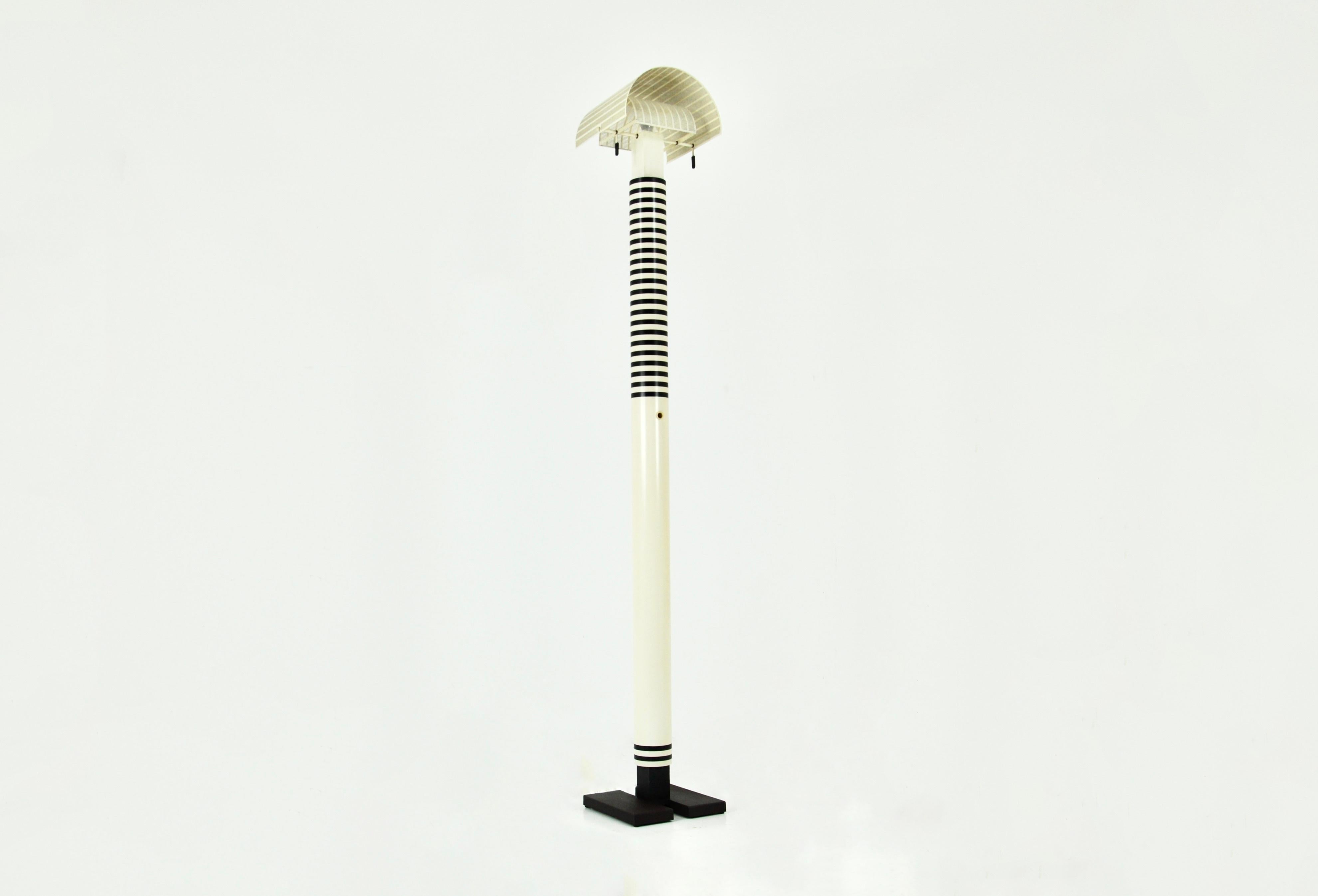 Black and white floor lamp in metal and plastic by Mario Botta. Model: Shogun. Tilting shade. Stamped Mario Botta. Wear due to time and age of the lamp.
  