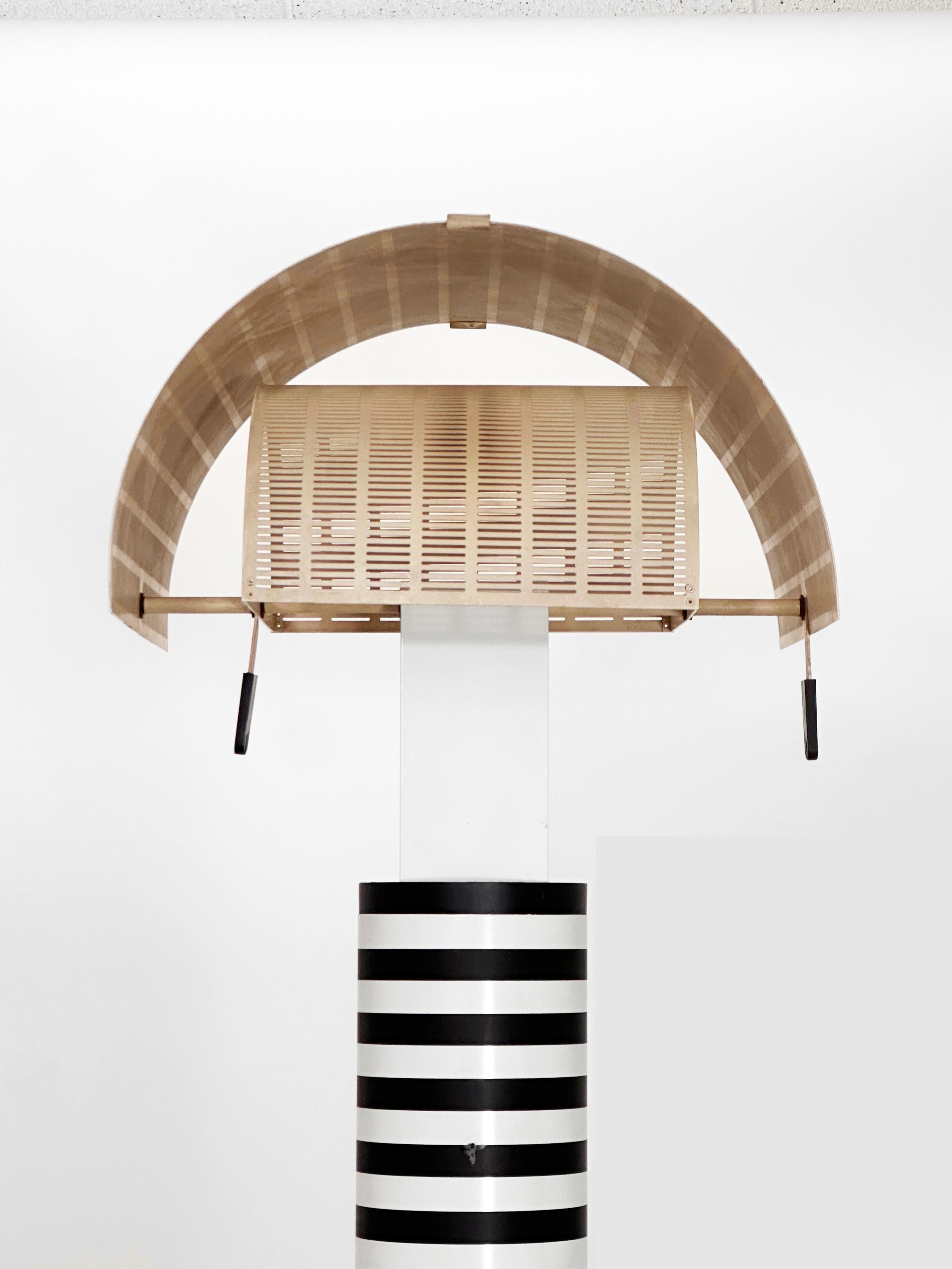 Un iconico design postmoderno dell'architetto e designer svizzero Mario Botta, la lampada da terra Shogun è stata prodotta da Artemide in Italia negli anni '80 e da allora è diventata uno dei progetti di illuminazione più celebri dell'azienda.

La