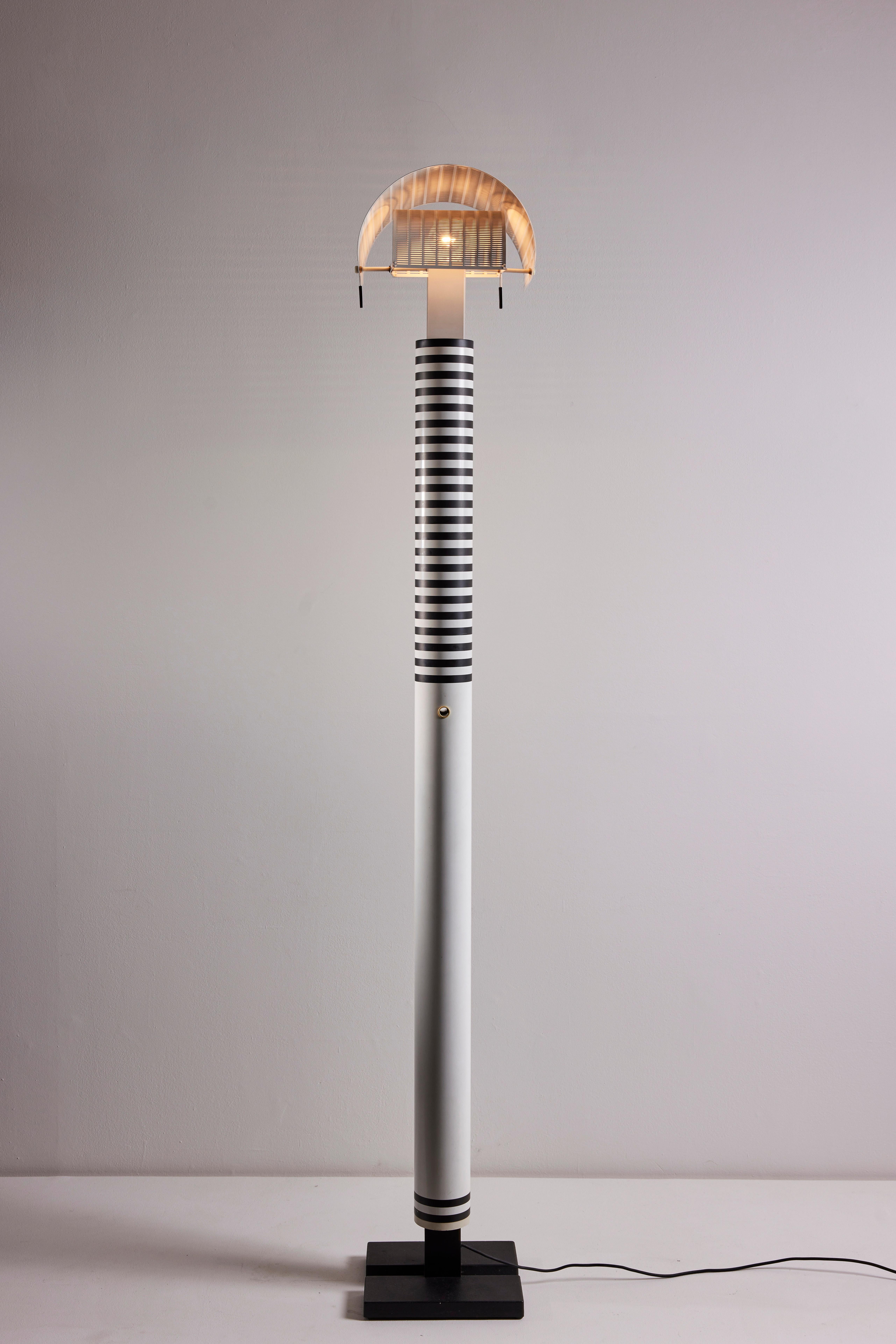 Shogun floor lamp by Mario Botta for Artemide. Designed and manufactured in Italy, circa 1980s. Enameled aluminum, enameled steel. Adjustable shade. Original European cord. We recommend on E26 60w maximum bulb. Bulb provided as a one time courtesy.