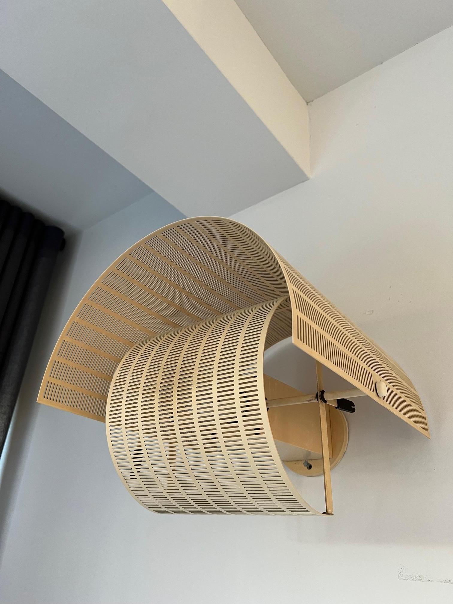 Very cool wall light by Mario Botta. It's from the first owner and has an nice effect when it's on. On the top and base you see some signs of aging but it won't be visible when it's hanging on the wall like you see on the pictures. It has this nice