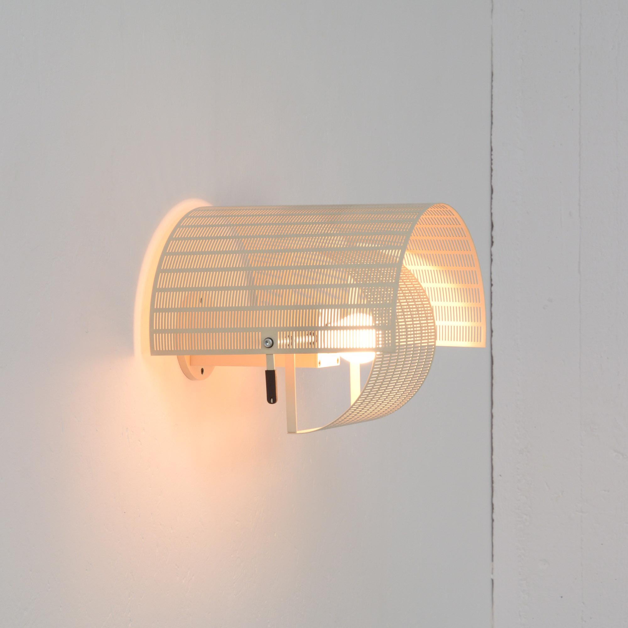 This sculptural wall lamp Shogun was designed by Mario Botta for Artemide, Italy in 1986.
The Postmodern Swiss architect and designer Mario Botta is renowned for his use of striking geometric forms. His Shogun lamp reflects his belief that lighting