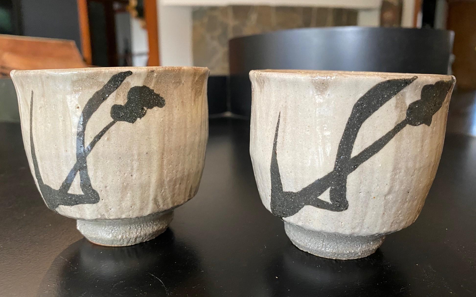 An exquisite set of Mingei Mashiko ware pottery Yunomi tea cups by master potter and Japanese National Human Cultural Treasure Shoji Hamada - a fine example of his hand applied oxide iron brush bamboo pattern motif with hakeme (Hakeme is a Japanese