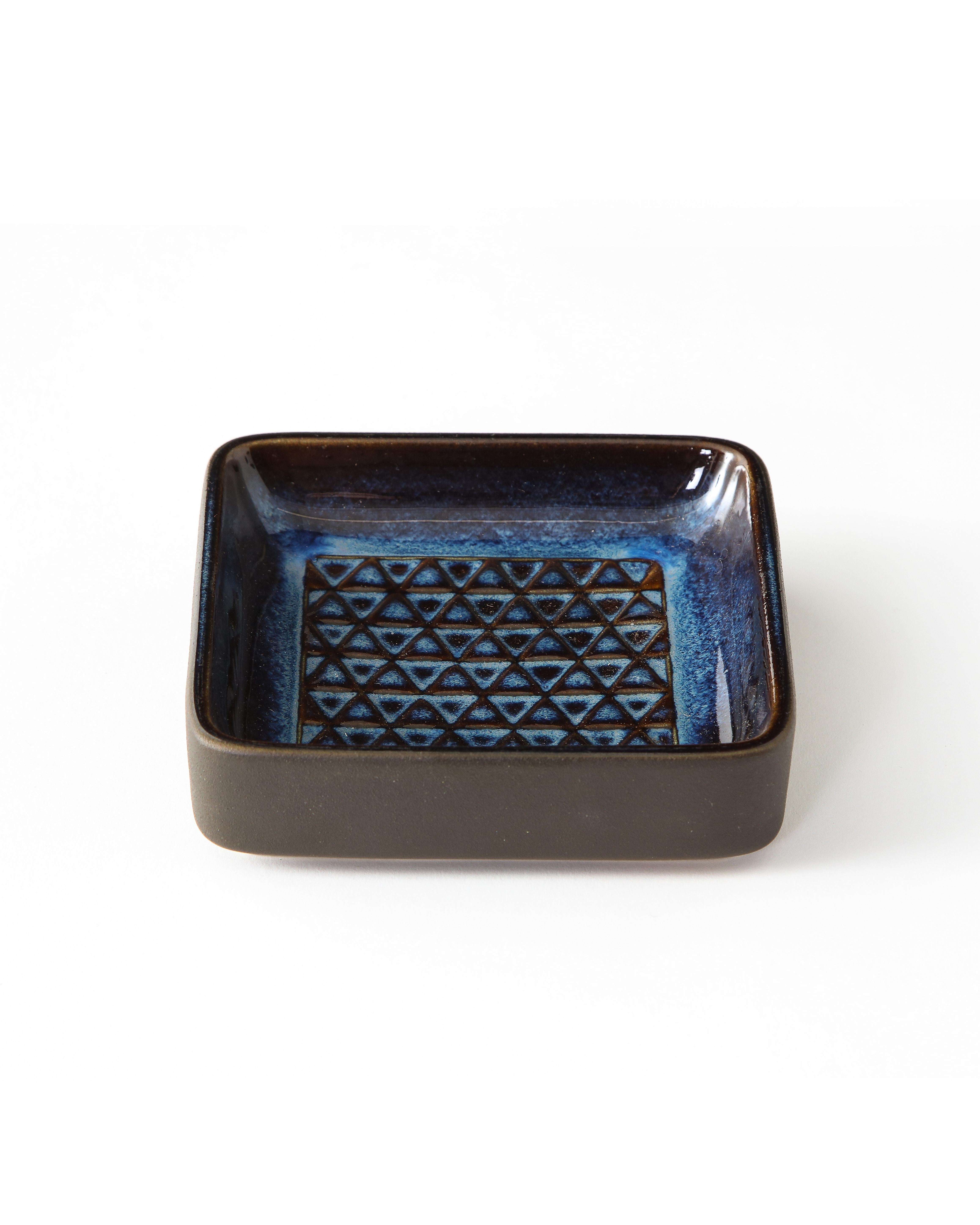 Lovely small square catch-all or table top object in handsome deep blue glaze. Pressed triangular pattern on interior. Highlights and lowlights of glaze are characteristic of this style of pottery. Marked and numbered Søholm, Denmark.