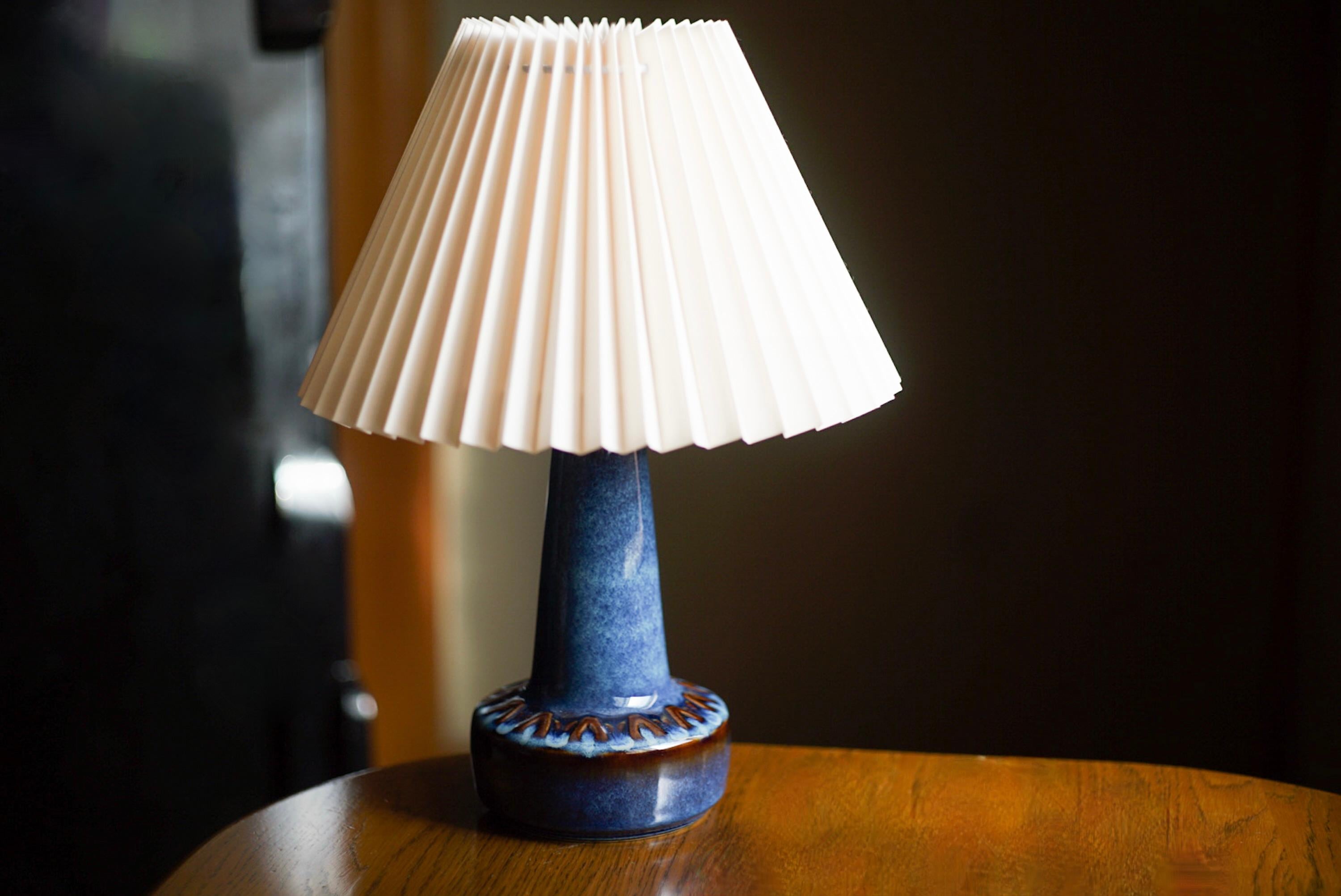 A table lamp produced by Søholm Keramik, located on the island of Bornholm in Denmark. Features a highly artistic glazed and incised decor.

Sold without lampshade. Stated dimensions exclude the lampshade. Height includes socket.
