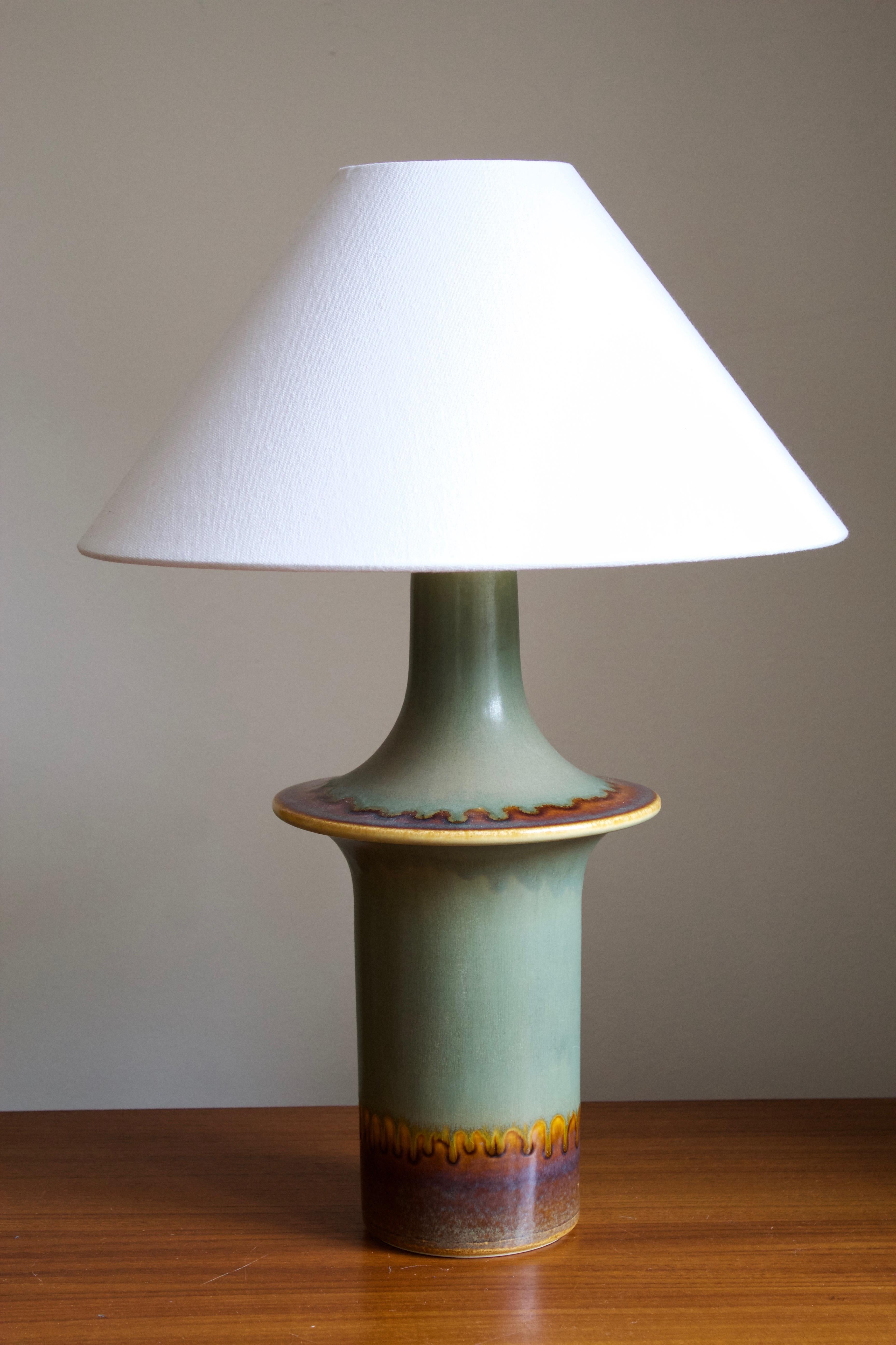 A large table lamp produced by Søholm Keramik, located on the island of Bornholm in Denmark. Features a highly artistic glazed and incised decor. 

Stated dimensions exclude the lampshade. Height includes socket. Sold without lampshade.

Other