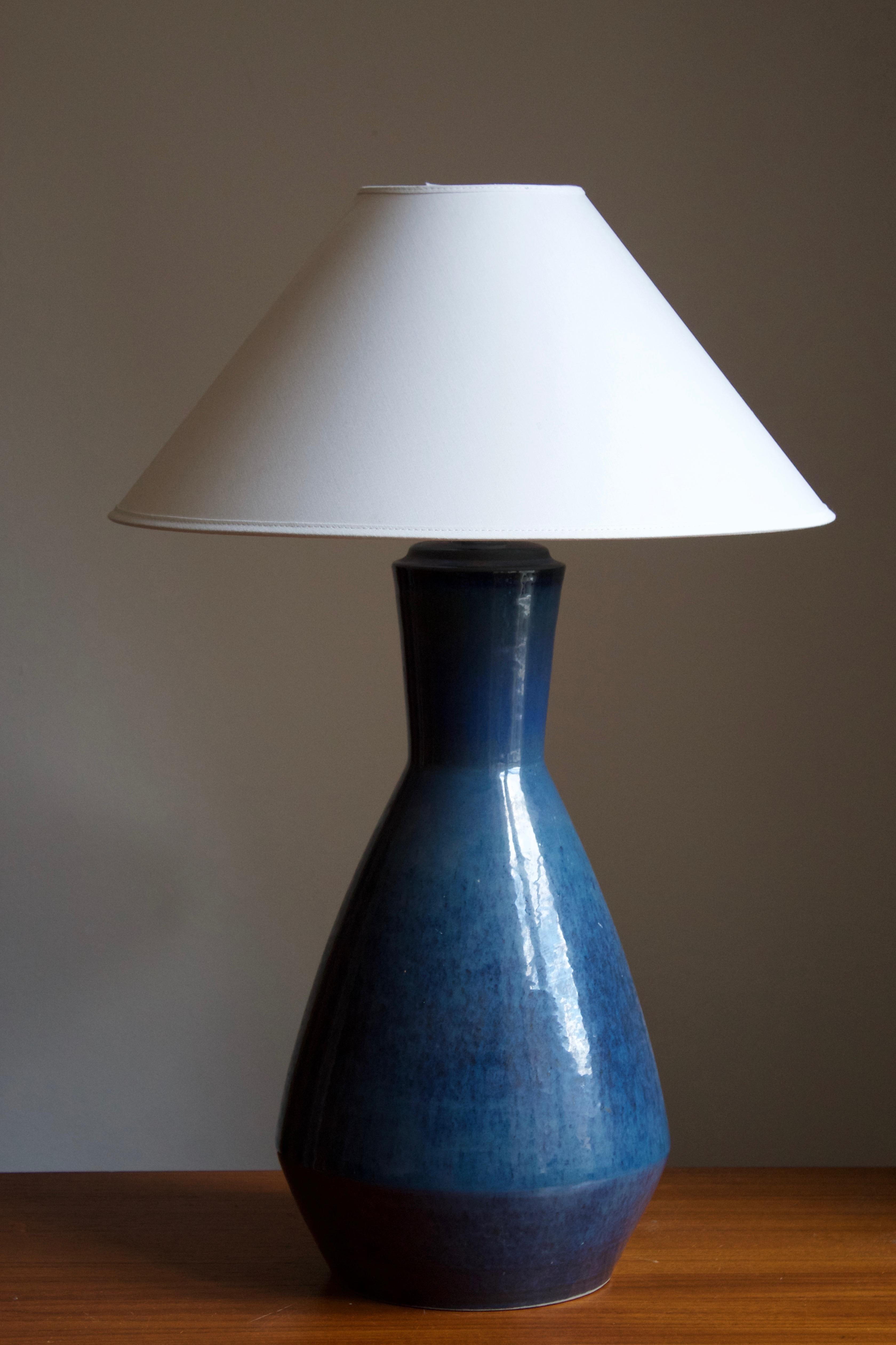 A large table lamp produced by Søholm Keramik, located on the island of Bornholm in Denmark. Features a highly artistic glaze. 

Sold without lampshade. Stated dimensions exclude the lampshade. Height includes socket.

Glaze features a blue