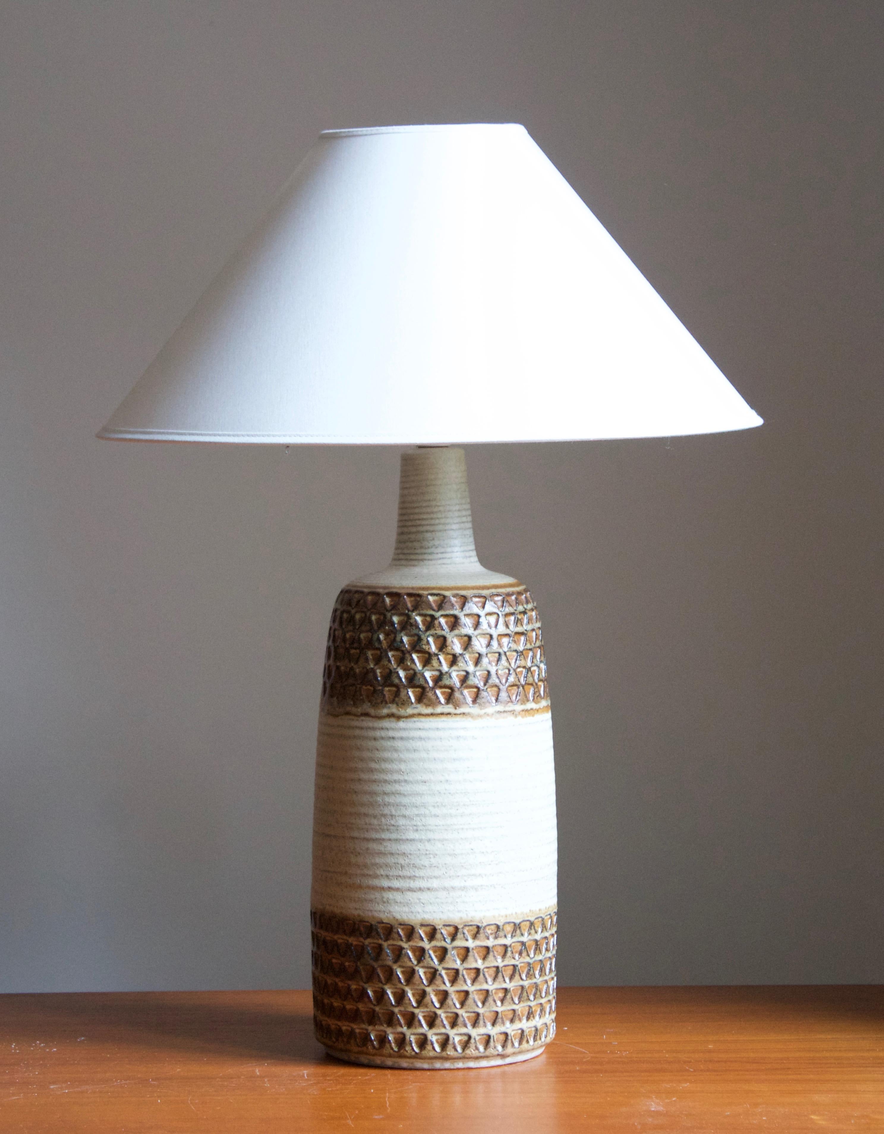 A large table lamp produced by Søholm Keramik, located on the island of Bornholm in Denmark. Features a highly artistic glazed decor. 

Sold without lampshade. Stated dimensions exclude the lampshade.

Glaze features brown-white colors.

Other