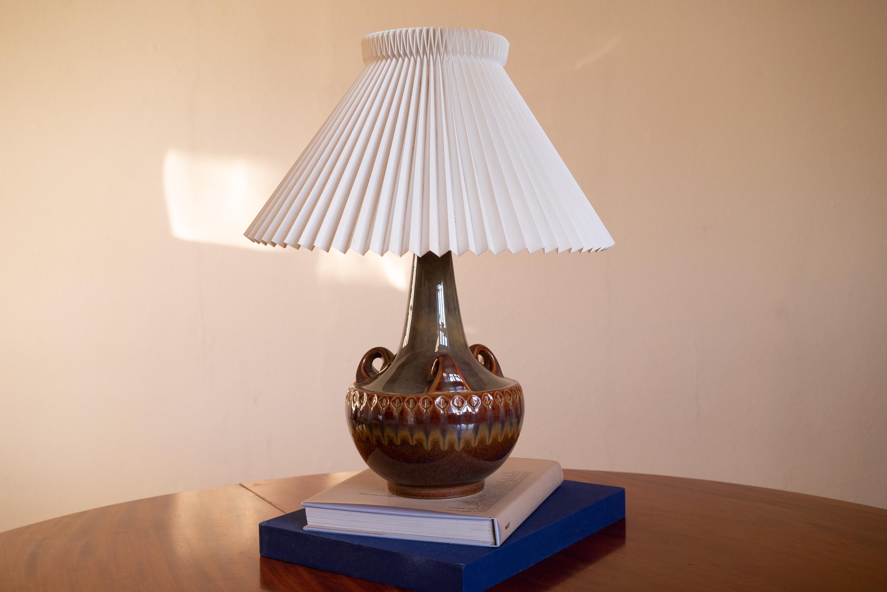 A large table lamp produced by Søholm Keramik, located on the island of Bornholm in Denmark. Features a highly artistic glazed decor.

Sold without lampshade. The stated dimensions exclude the lampshade.

The glaze features brown-white colors.