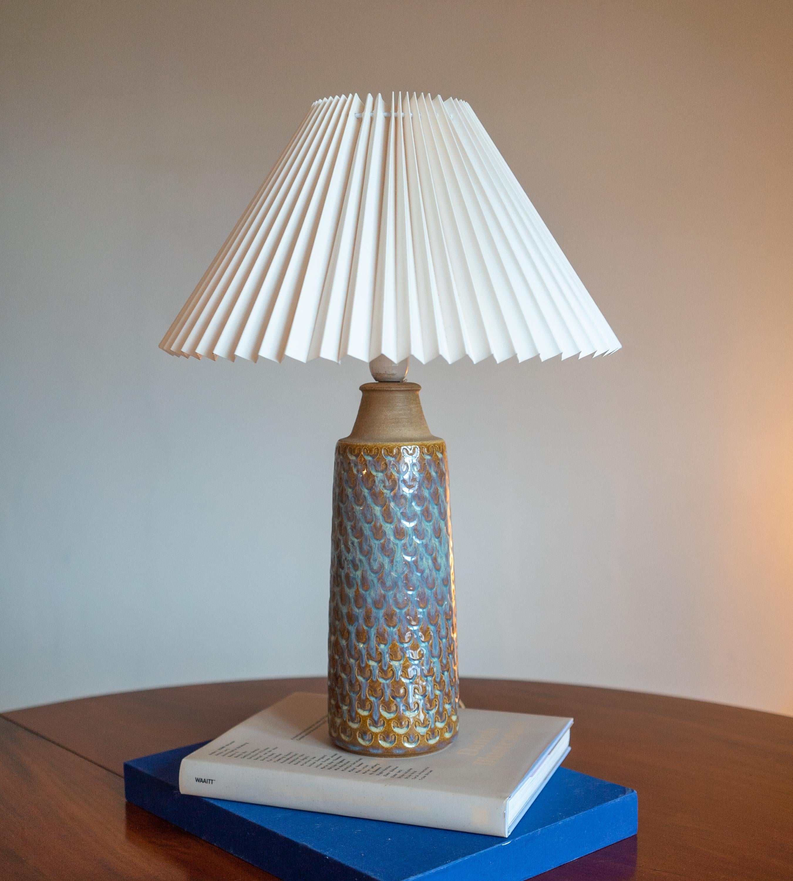 A large table lamp produced by Søholm Keramik, located on the island of Bornholm in Denmark. Features a highly artistic glazed decor.

Sold without lampshade. Stated dimensions exclude the lampshade.

Glaze features brown-white colors.
