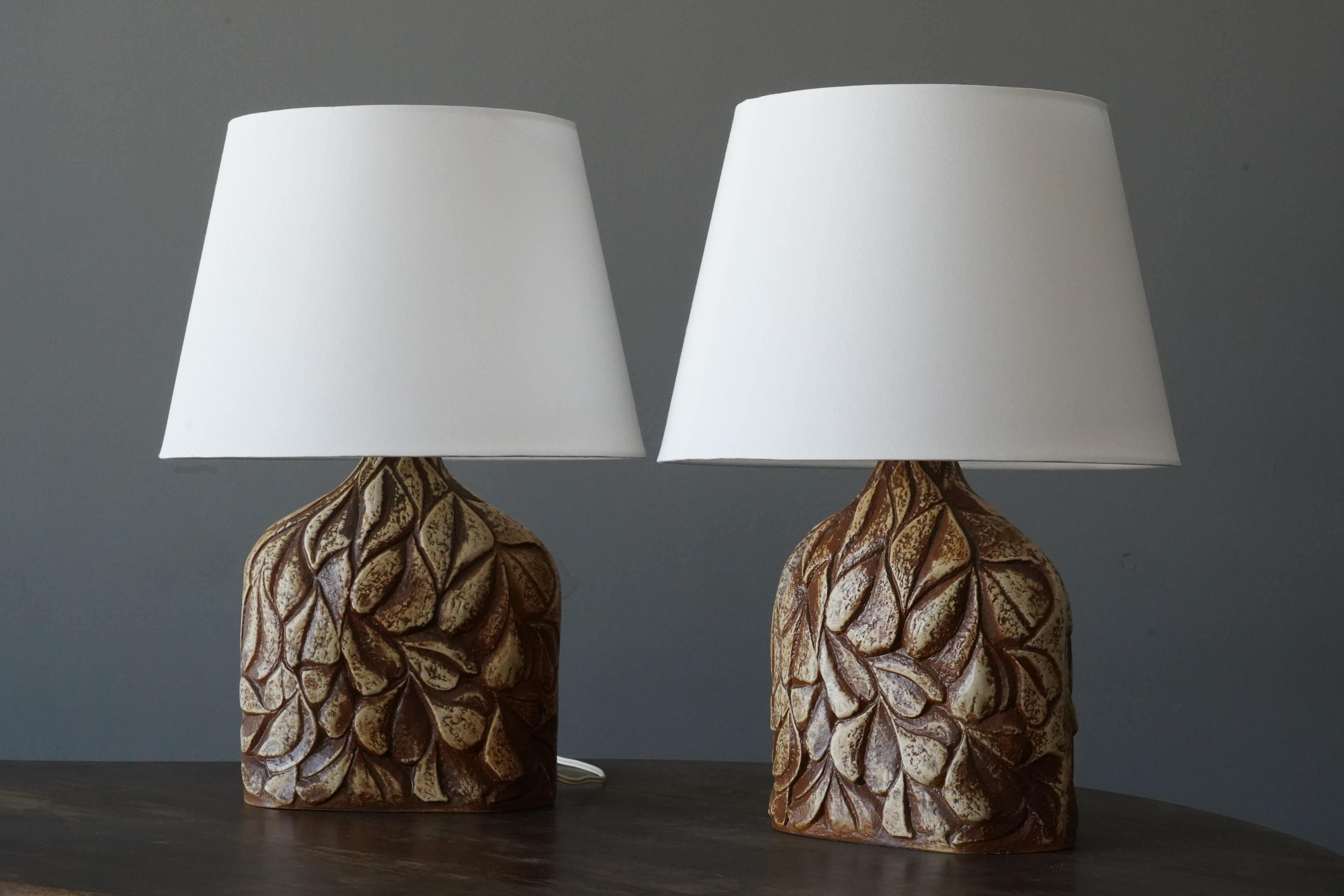 A pair of large table lamps produced by Søholm Keramik, located on the island of Bornholm in Denmark. Features a highly artistic decor. 

Sold without lampshade. Stated dimensions exclude the lampshade.

Glaze features brown-beige colors.

Other