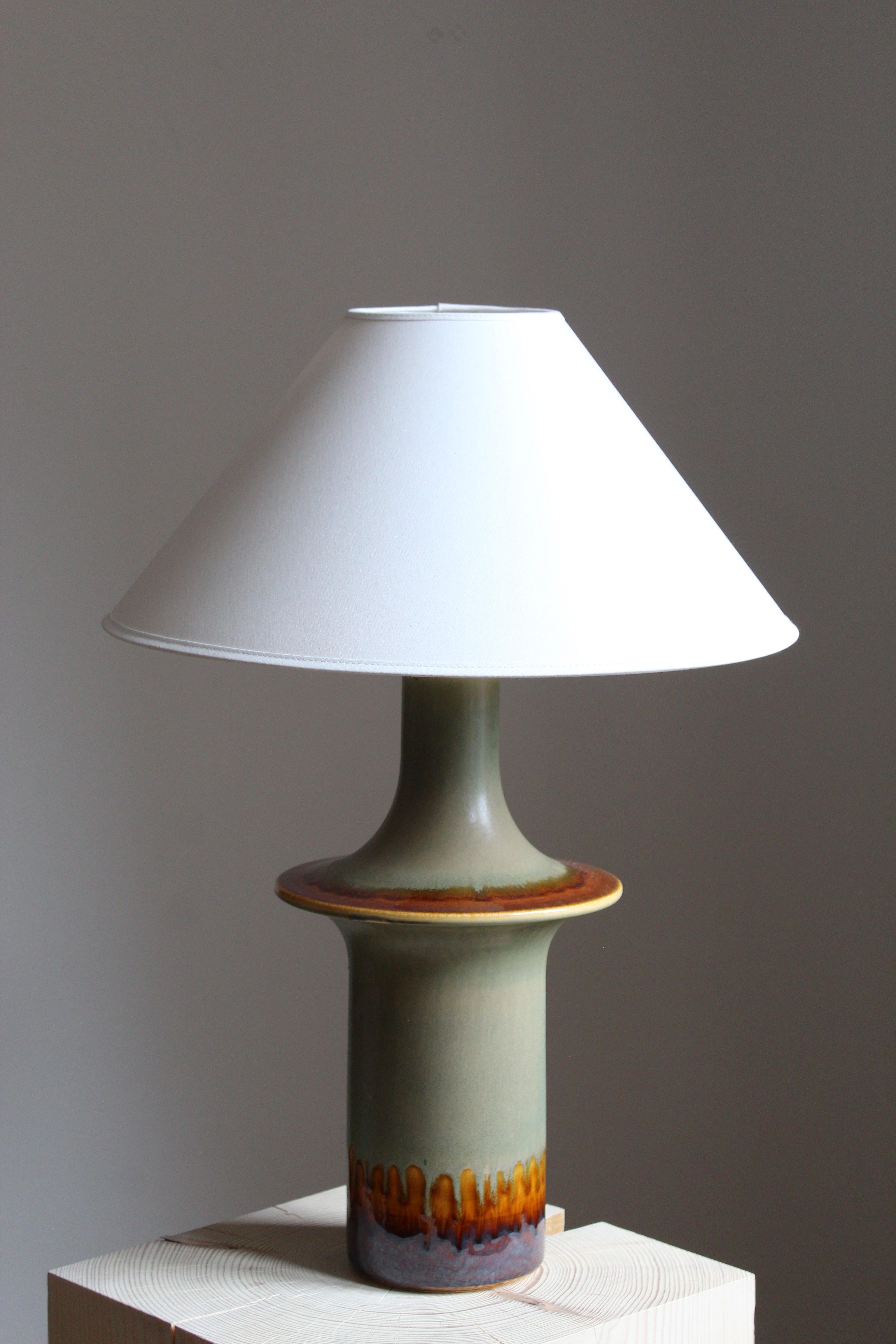 A sizable table lamp produced by Søholm Keramik, located on the island of Bornholm in Denmark. 

Glaze features green-blue-brown colors.

Sold without lampshade, stated dimensions excluding lampshade.
