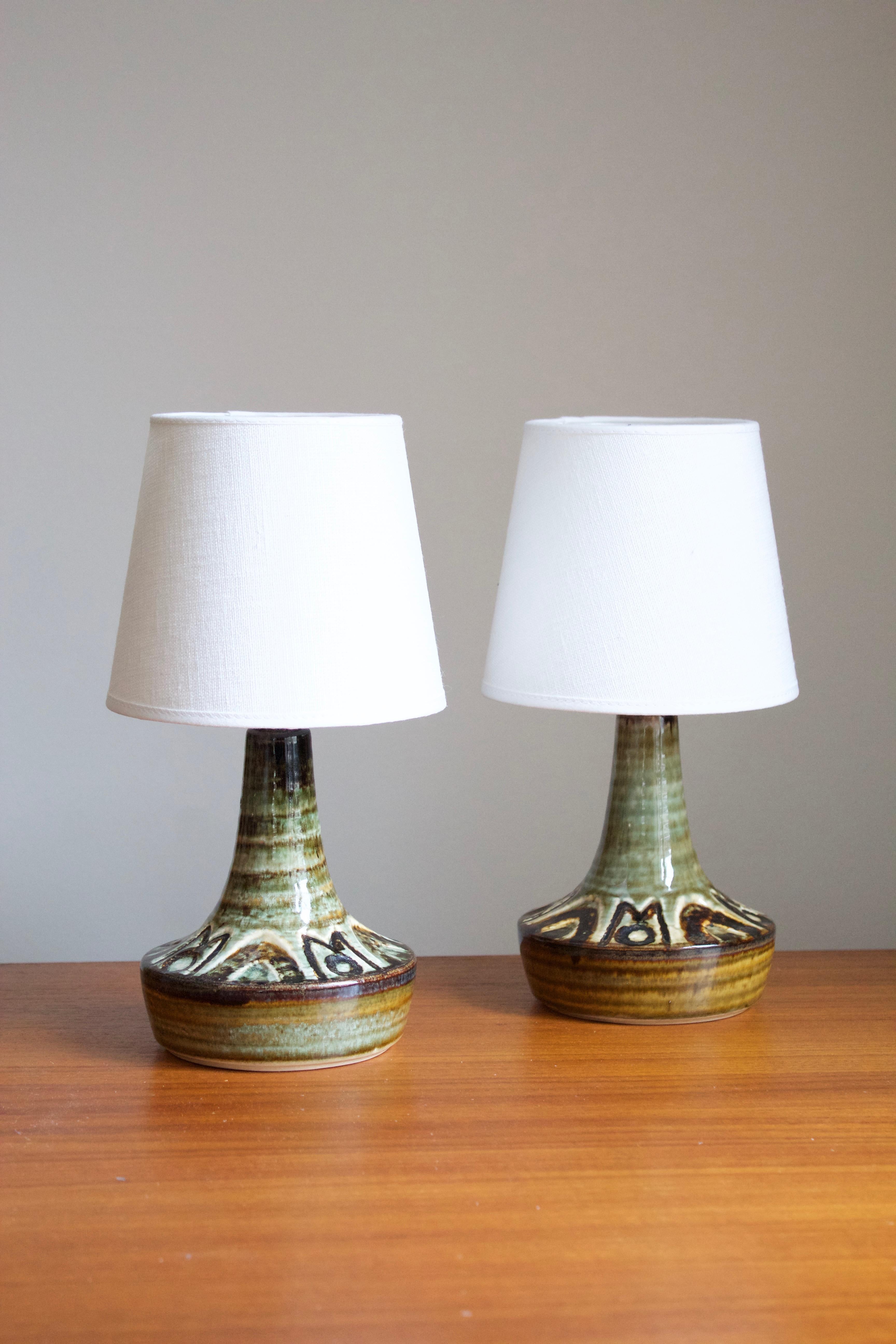 A pair of large table lamps produced by Søholm Keramik, located on the island of Bornholm in Denmark. Features a highly artistic glazed decor. 

Sold without lampshades.

Glaze features brown-green-yellow colors.

Other designers of the period