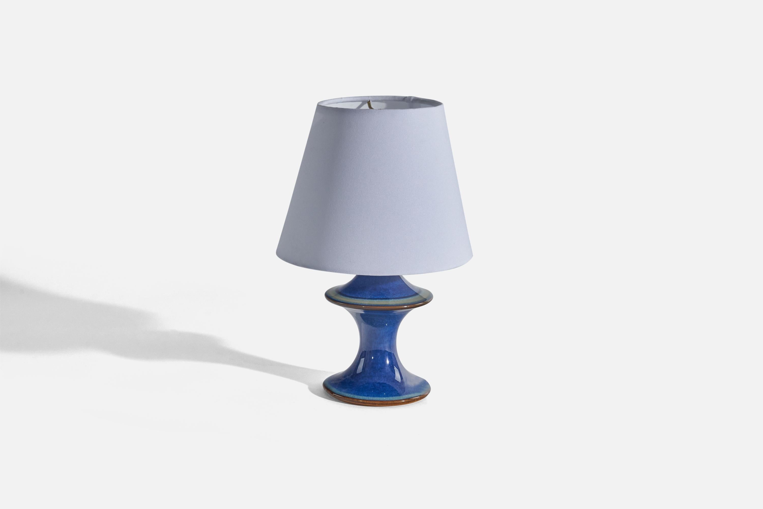 A blue-glazed stoneware table lamp designed and produced by Søholm Keramik, Bornholm, Denmark, c. 1970s. 

Sold without Lampshade(s)
Dimensions of Lamp (inches) : 8.56 x 4.62 x 4.62 (Height x Width x Depth)
Dimensions of Shade (inches) : 5.12 x 8.18
