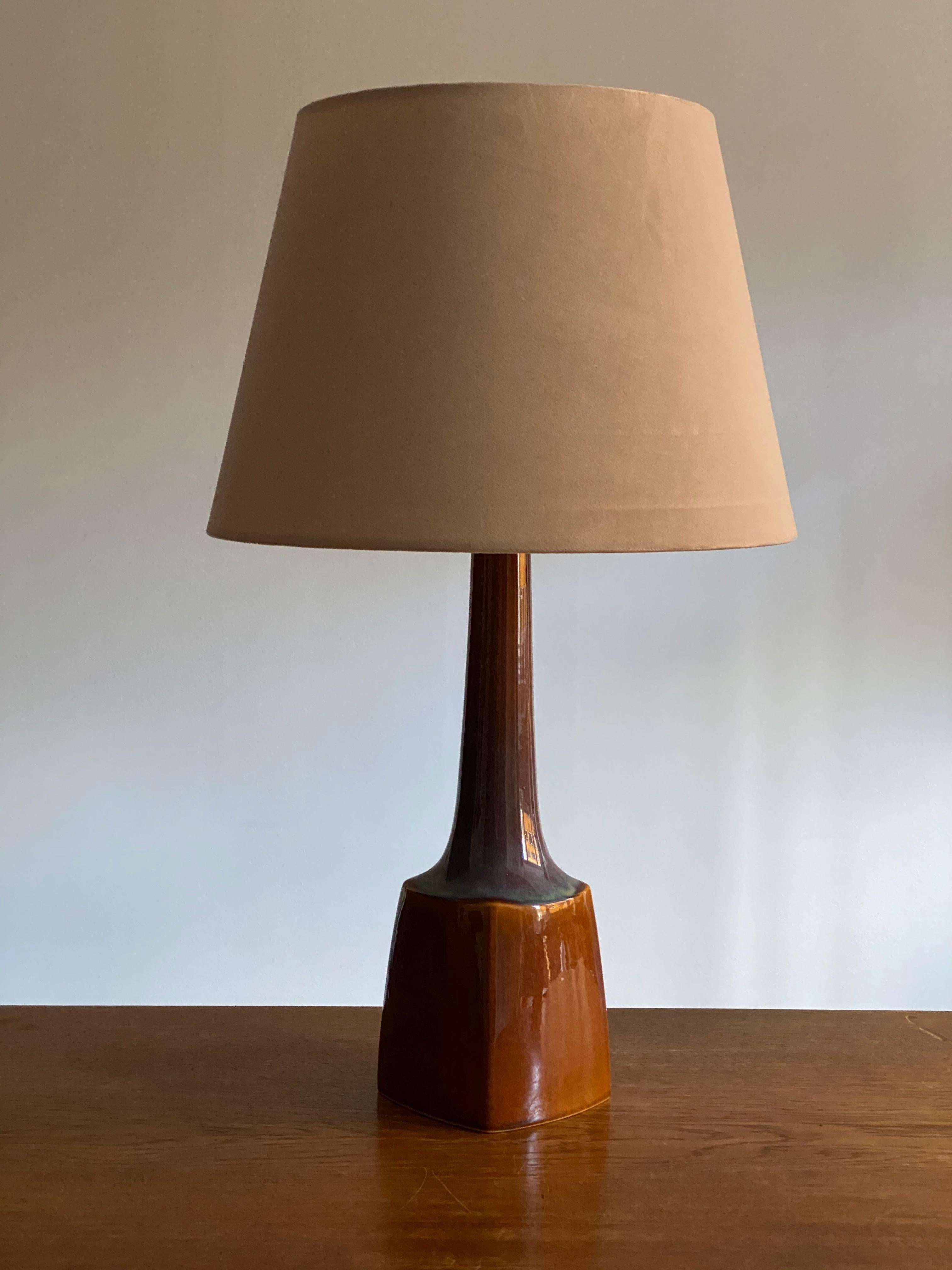 A table lamp produced by Søholm Keramik, located on the island of Bornholm in Denmark. In highly artistic blue / brown glaze. 

Lampshade is attached for reference and are not included in the purchase. Measured without lampshade.

Other