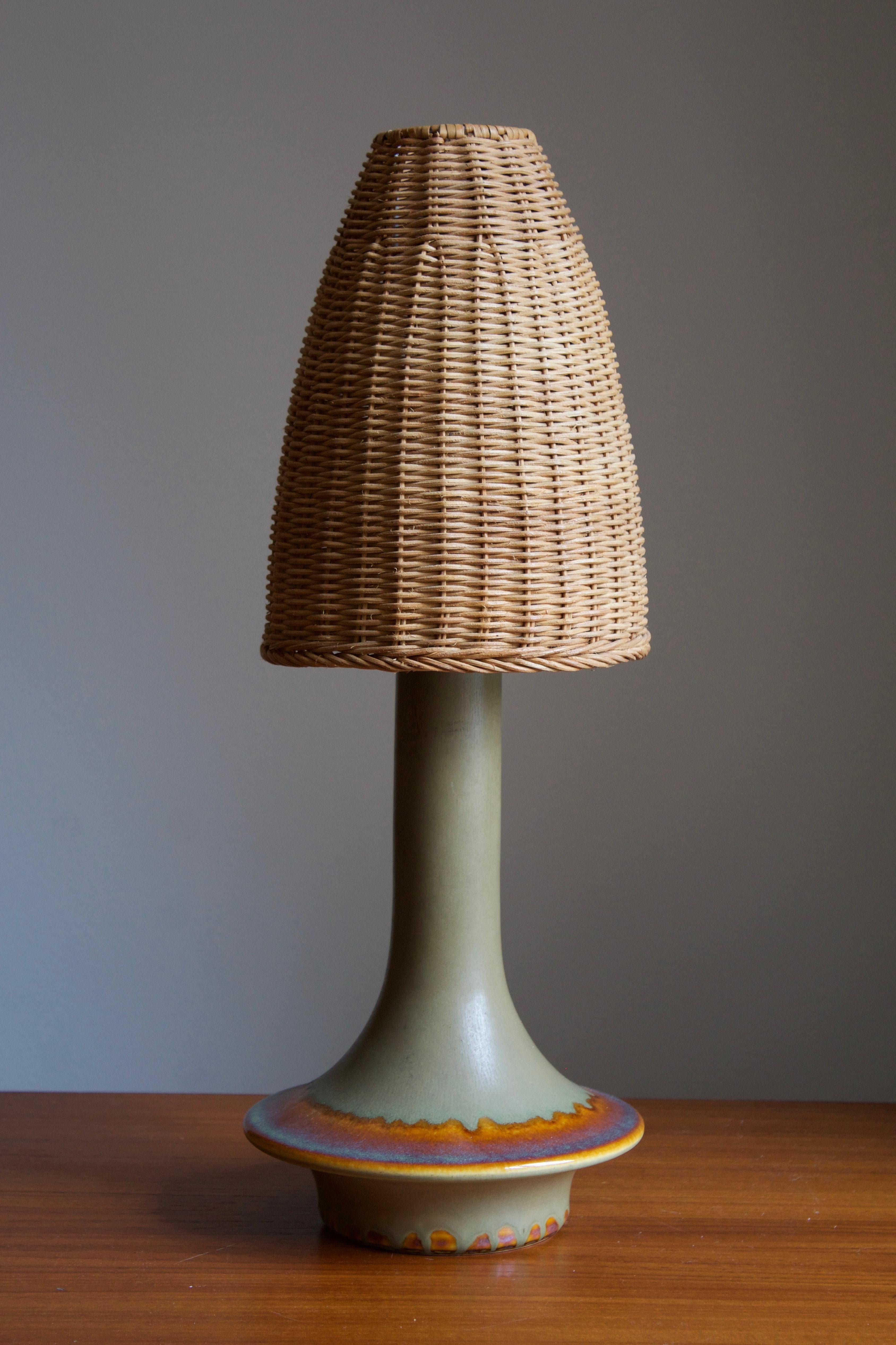 A large table lamp produced by Søholm Keramik, located on the island of Bornholm in Denmark. Features a highly artistic glazed and incised decor. 

Stated dimensions exclude the lampshade. Height includes socket. Illustrated rattan lampshade can be