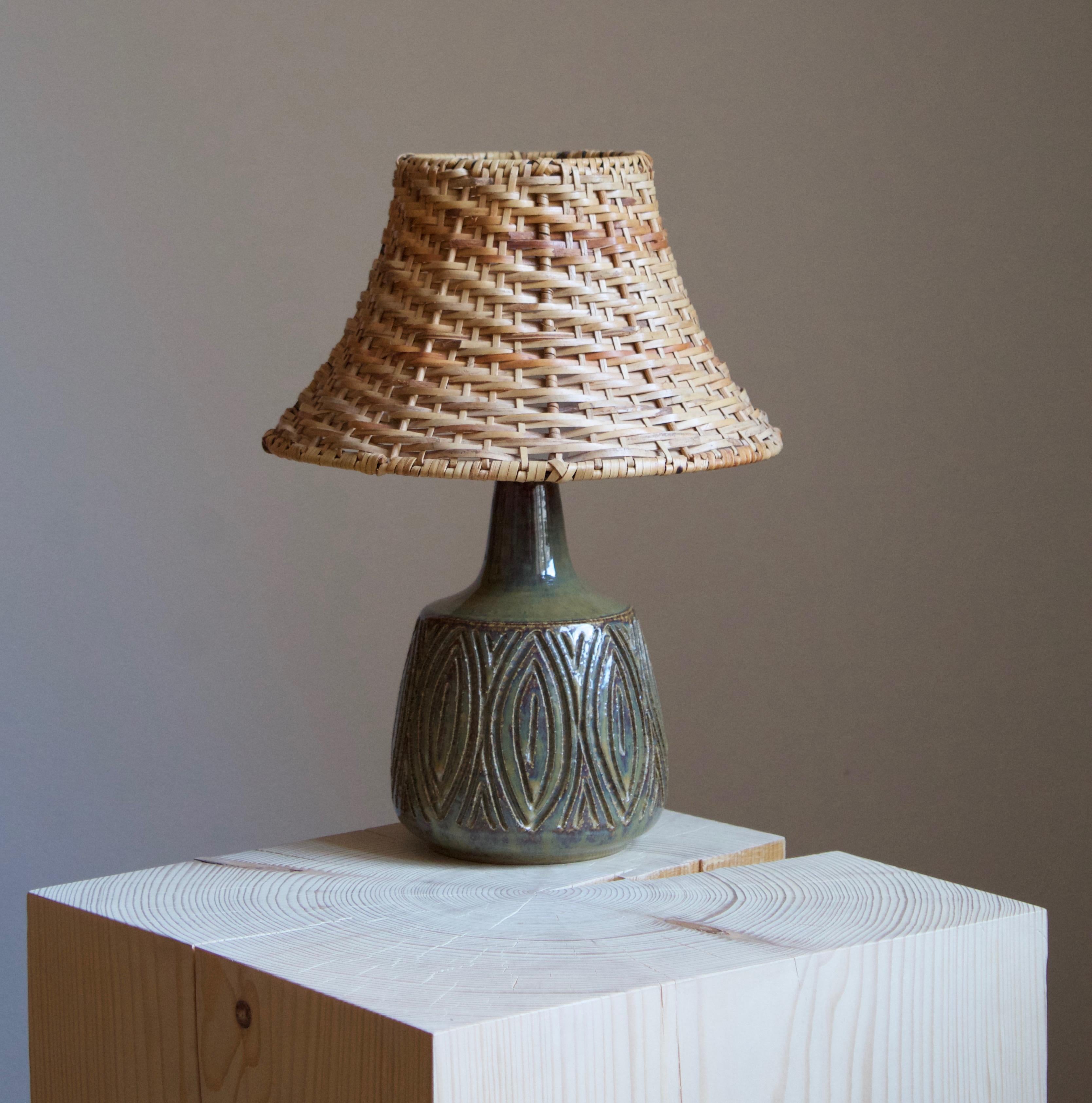A pair of large table lamps produced by Søholm Keramik, located on the island of Bornholm in Denmark. Features a highly artistic decor. 

Stated dimensions exclude the lampshade. Height includes socket. Upon request illustrated model vintage rattan