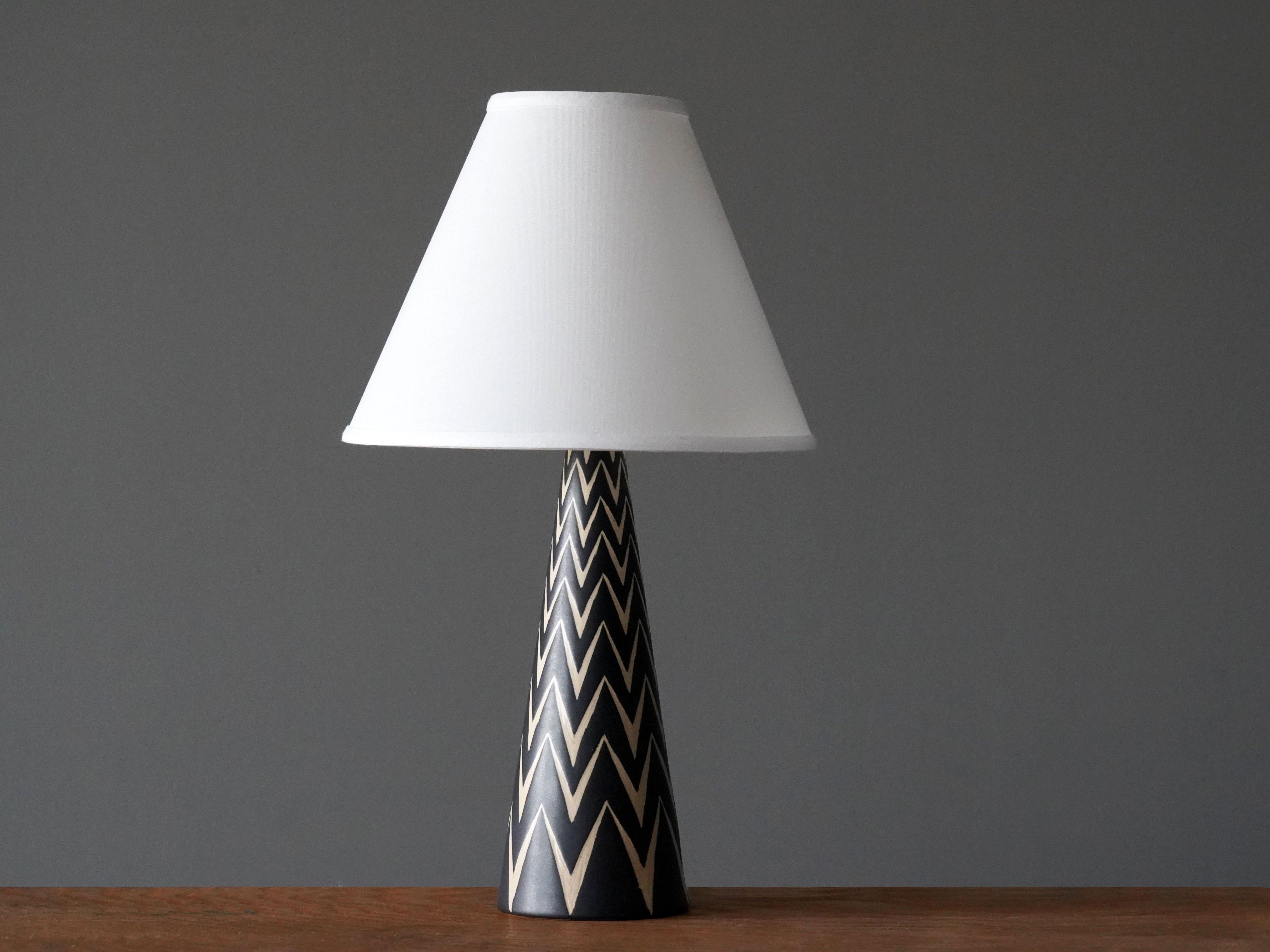A table lamp produced by Michael Andersen Keramik. In hand painted stoneware. Sold without lampshade.

Other ceramicists of the period include Axel Salto, Arne Bang, Carl-Harry Stålhane, and Berndt Friberg.