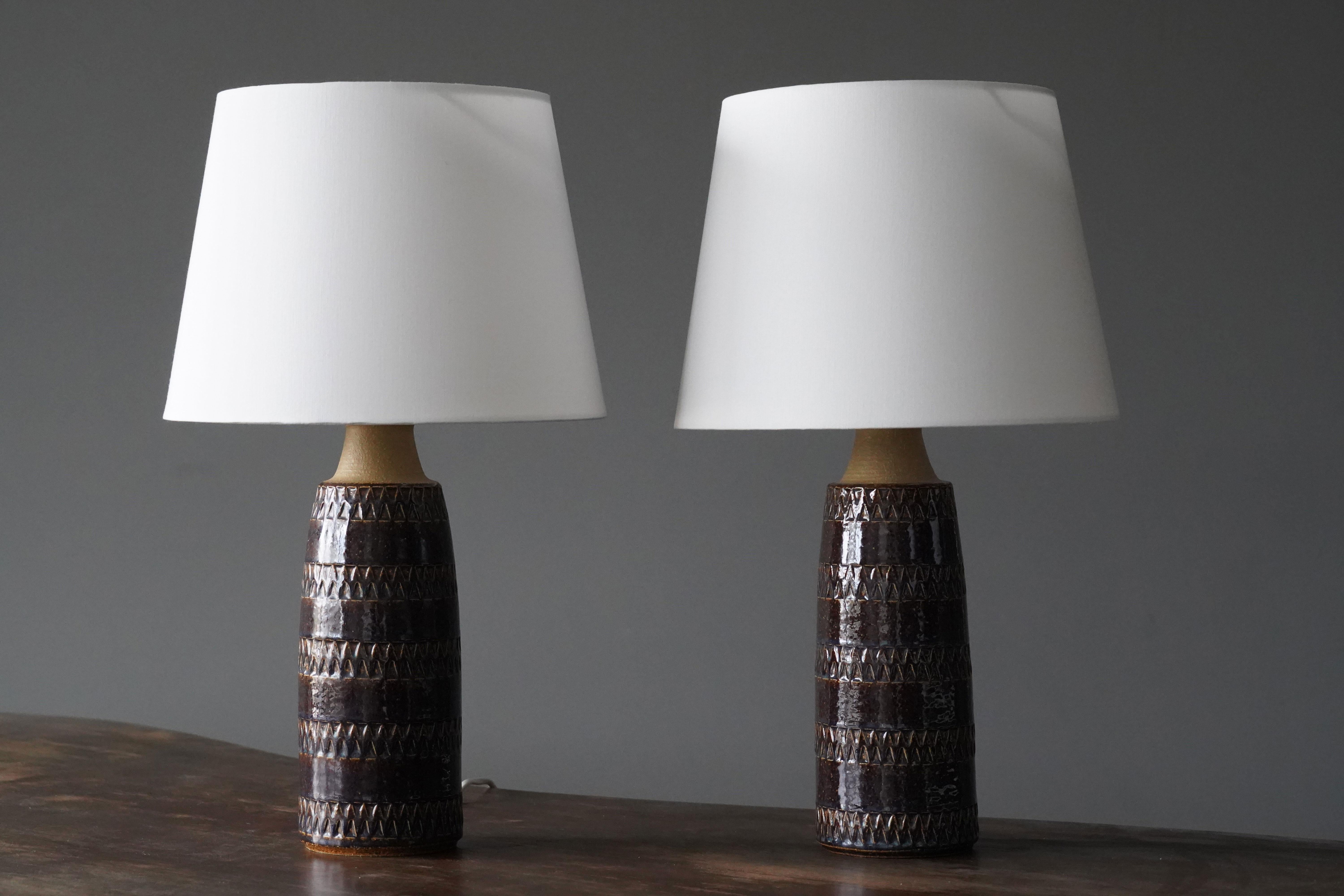 A pair of table lamps produced by Søholm Keramik, located on the island of Bornholm in Denmark. In a highly artistic brown / beige glaze with hints of blue. 

Lampshades are attached for reference and are not included in the purchase. Dimensions