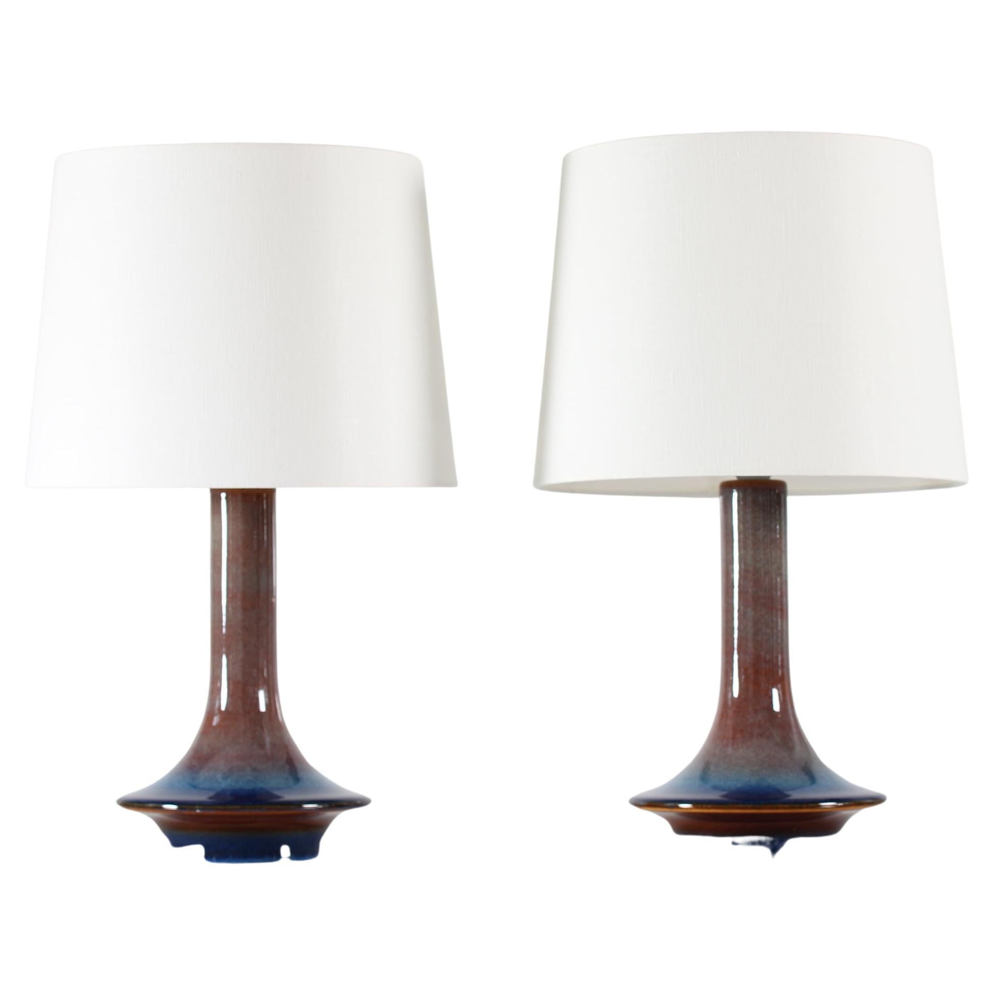 Rare pair of sculptural ufo sharped table lamps made by Søholm Stentøj model no. 1068, Denmark, circa 1960s.
The lamps are decorated with glaze in a beautiful color play in brown, blue, green and orange 

Included are a new lamp shades designed