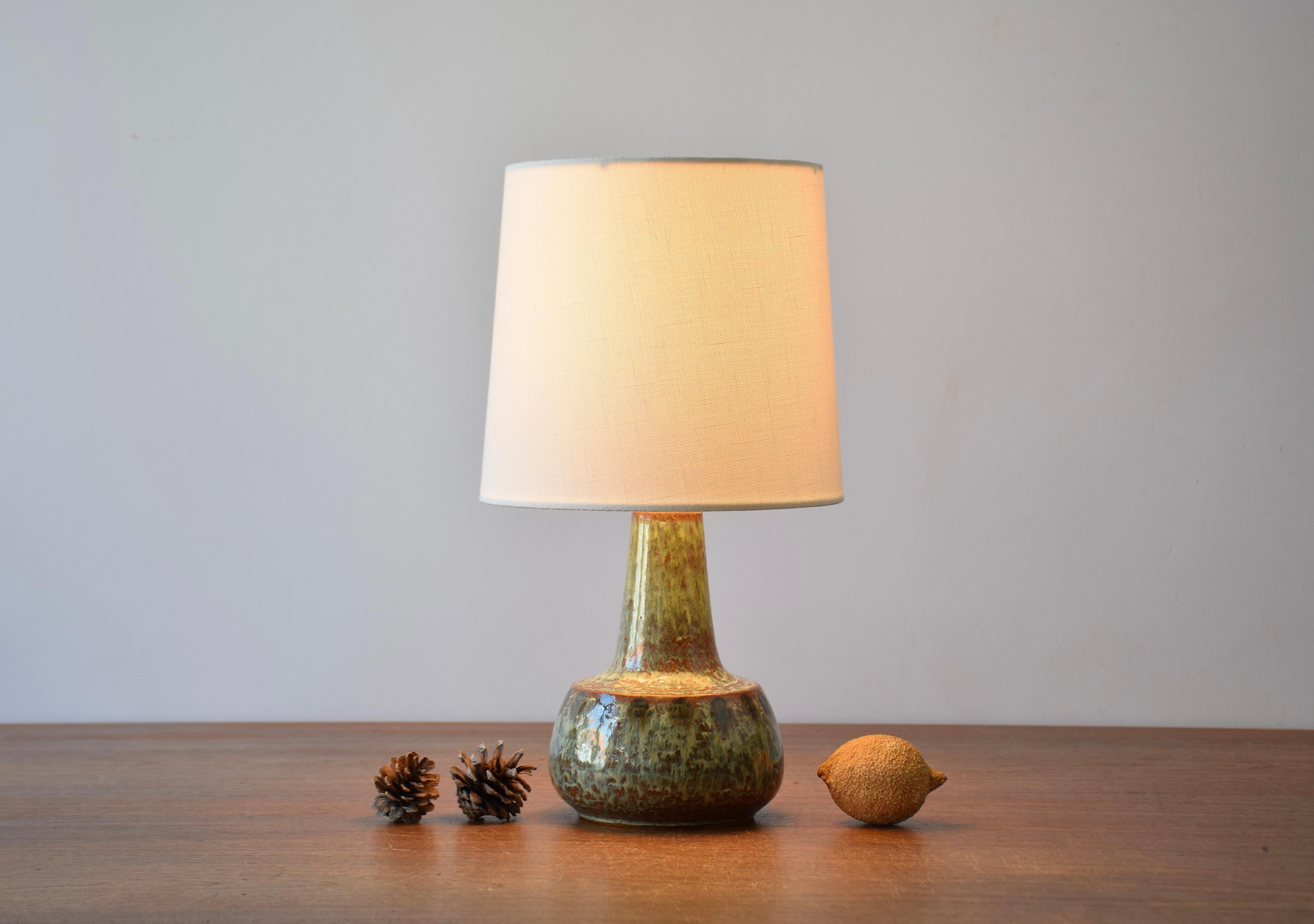 Mid-century Danish stoneware bedside lamp by Søholm Stentøj, Denmark. Made circa 1960´s.
The handmade lamp is decorated with a glossy brown and green glaze in different shades.

Included is a new lamp shade designed and made in Denmark. It is made