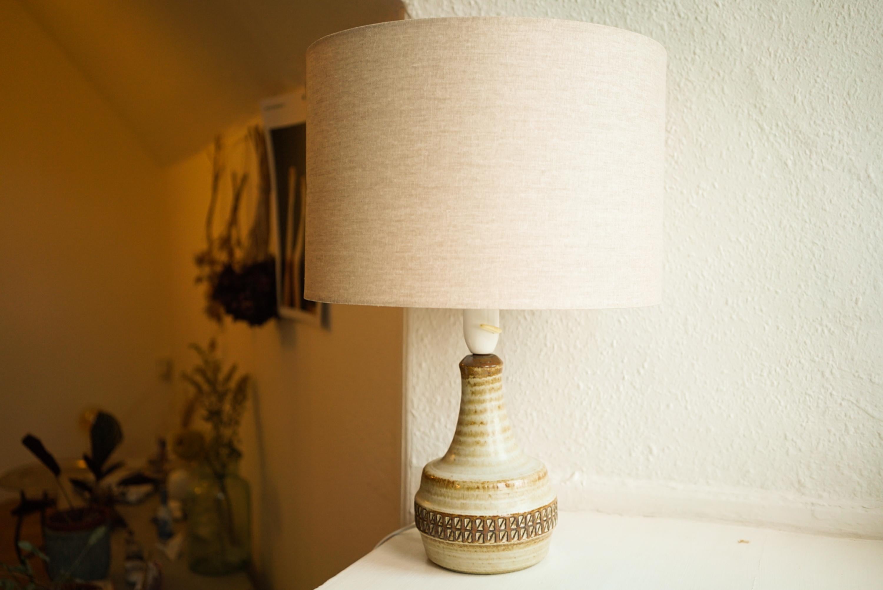 A stoneware table lamp handmade by Josef Simon for Danish Søholm located on the island of Bornholm in Denmark in the 1960s.

Stamped and signed on the base.

Sold without lampshade. Height includes socket. fully functional and in beautiful