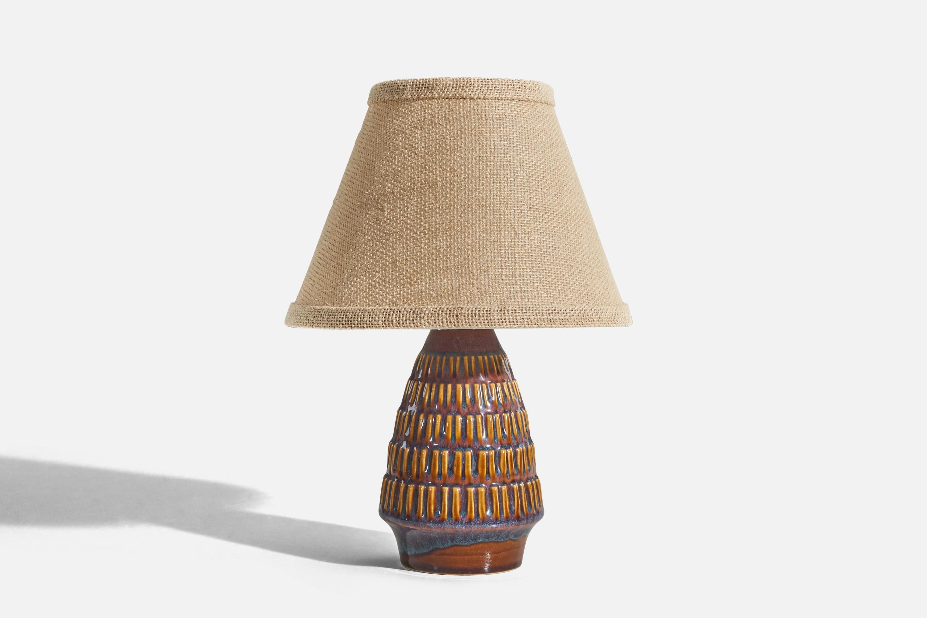 A blue, yellow and brown, glazed stoneware table lamp designed and produced by Søholm Stentøj, Denmark, c. 1960s.

Sold without lampshade. 
Dimensions of lamp (inches) : 8.56 x 4 x 4 (H x W x D)
Dimensions of shade (inches) : 4.25 x 8.25 x 6 (T