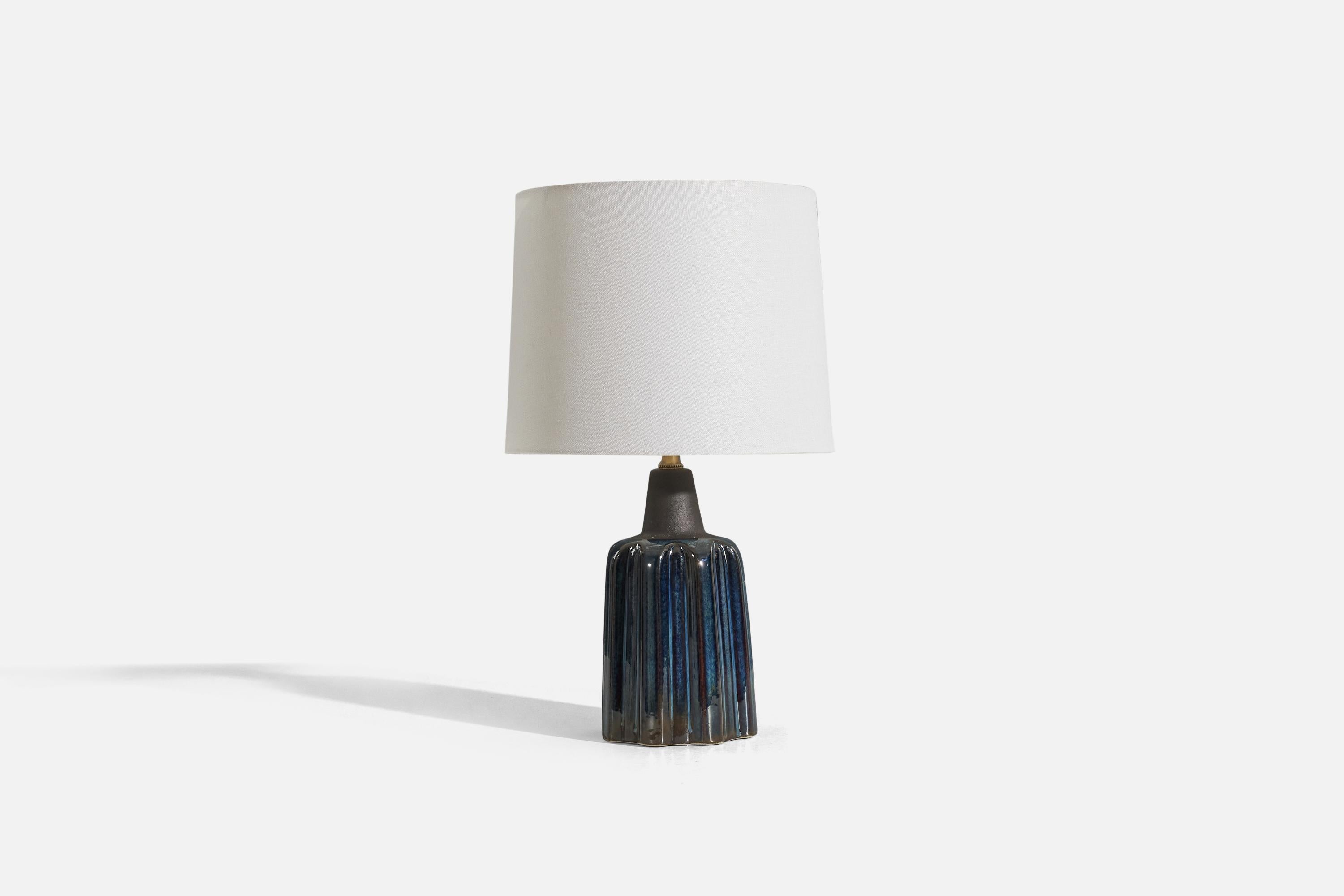 A blue, glazed stoneware table lamp designed and produced by Søholm Stentøj, Denmark, c. 1960s.

Sold without lampshade. 
Dimensions of Lamp (inches) : 12.25 x 5 x 5 (H x W x D)
Dimensions of Shade (inches) : 9.125 x 10 x 7.875 (T x B x S)
Dimension