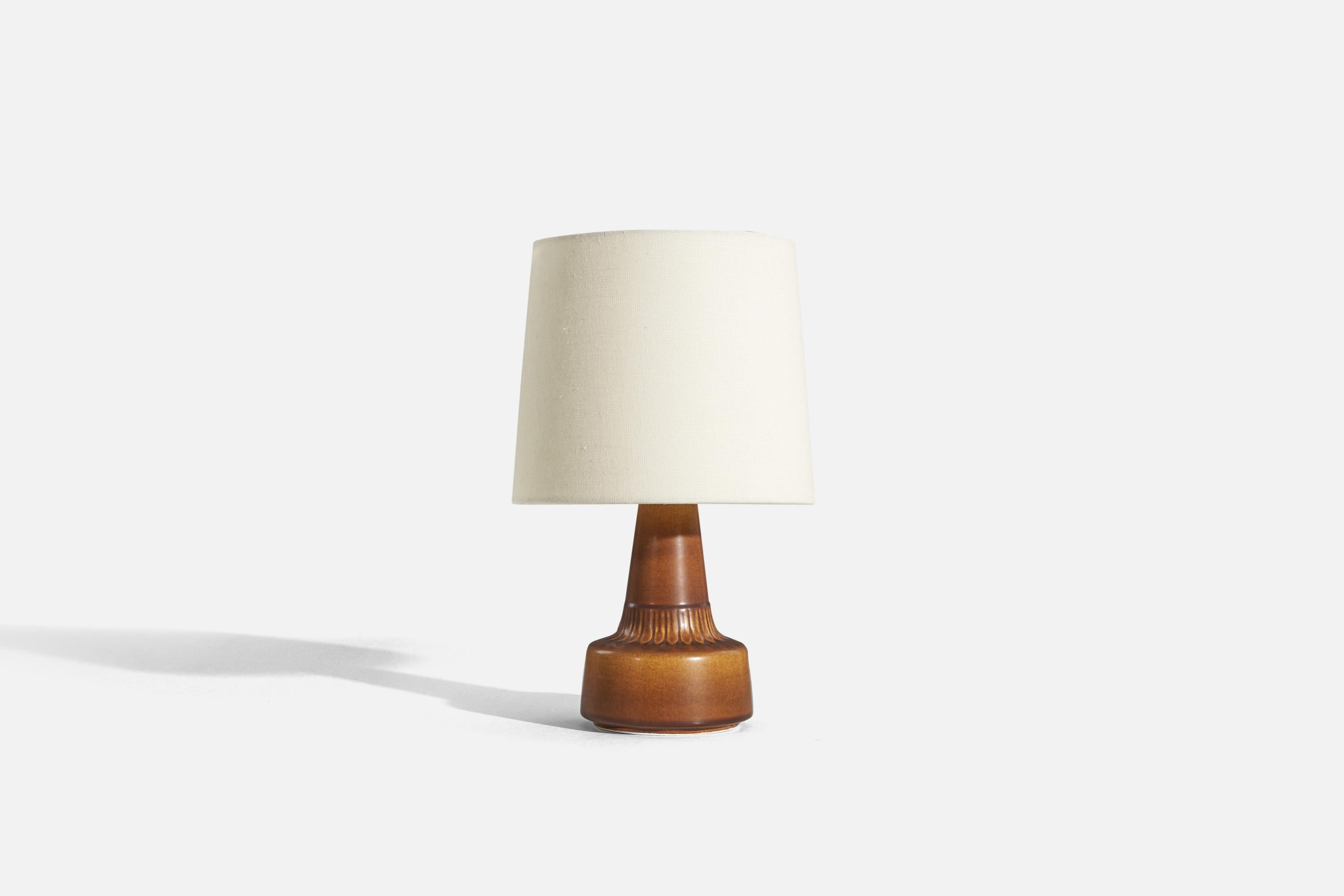 A brown, glazed stoneware table lamp designed and produced by Søholm Stentøj, Bornholm, Denmark, 1960s.

Sold without lampshade. 
Dimensions of Lamp (inches) : 8.8125 x 4.75 x 4.75 (H x W x D)
Dimensions of Shade (inches) : 7 x 8 x 7 (T x B x