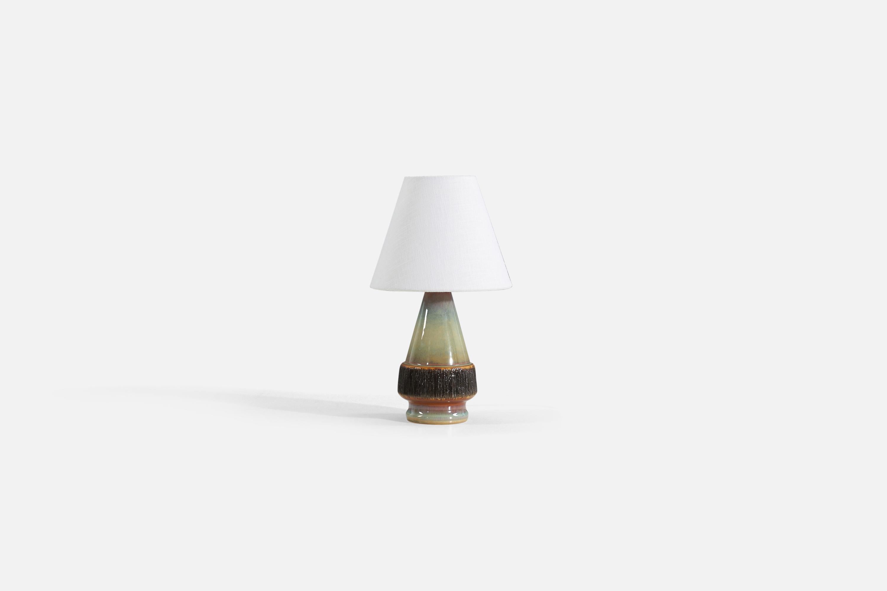 A glazed stoneware table lamp, produced by Søholm Stentøj, Denmark, 1960s.

Sold without lampshade. 

Measurements listed are of lamp.
Shade : 4 x 8 x 6.5
Lamp with shade : 14.25 x 8 x 8.