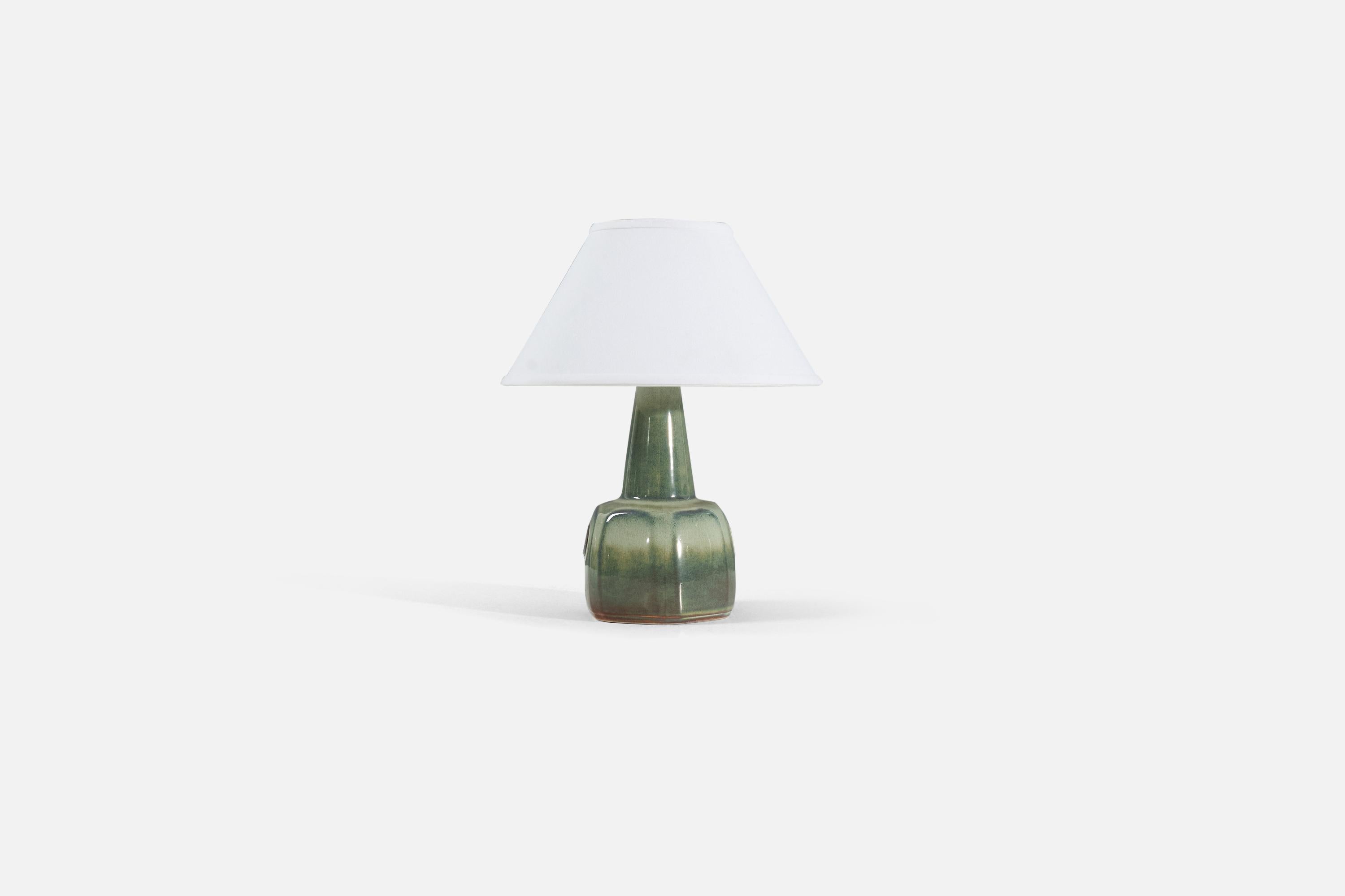 A green-glazed stoneware table lamp, produced by Søholm Stentøj, Sweden, 1960s.

Lamp sold without a lampshade. 

Measurements listed are of lamp. 
Shade : 5 x 12.25 x 7.25
Lamp with shade : 15.5 x 12.25 x 12.25.