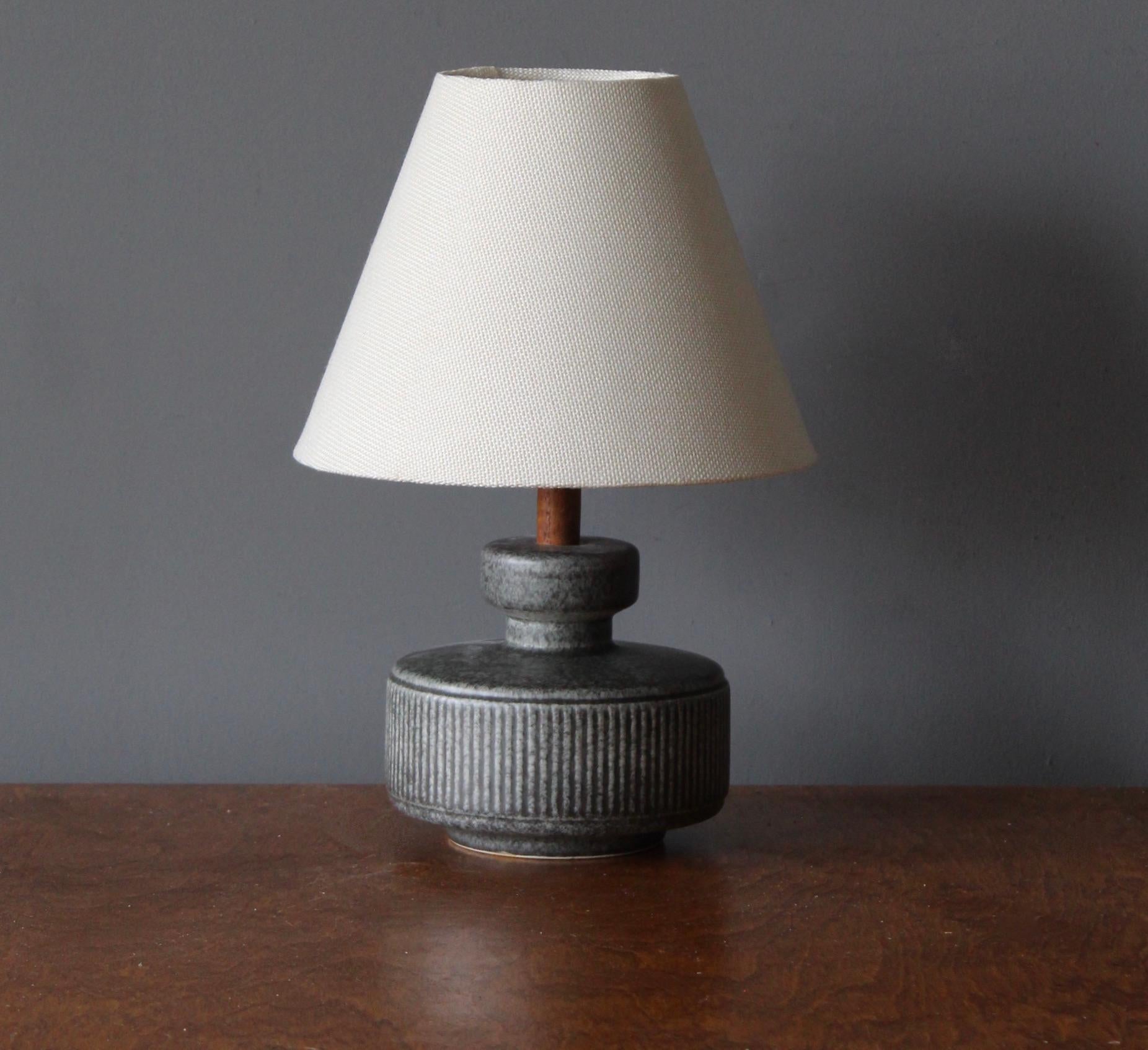 A table lamp produced by Søholm Keramik, located on the island of Bornholm in Denmark. Features a highly artistic glazed and incised decor. 

Sold without lampshade. Stated dimensions exclude the lampshade. Height includes socket.

Other