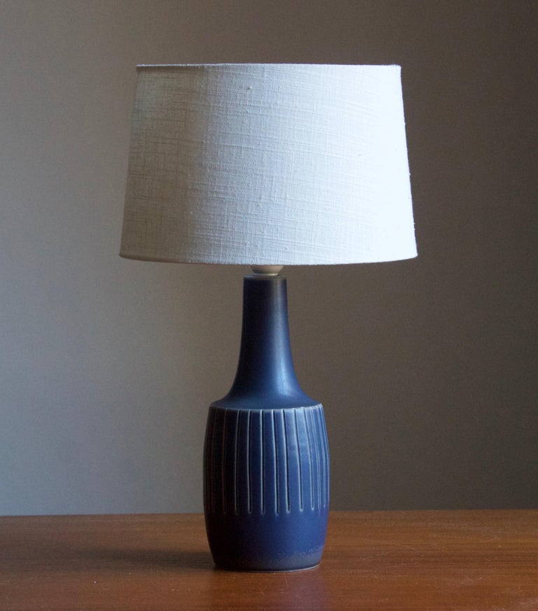 A table lamp produced by Søholm Keramik, located on the island of Bornholm in Denmark. Features a highly artistic glazed and incised decor. 

Sold without lampshade. Stated dimensions exclude the lampshade. Height includes socket.

Other