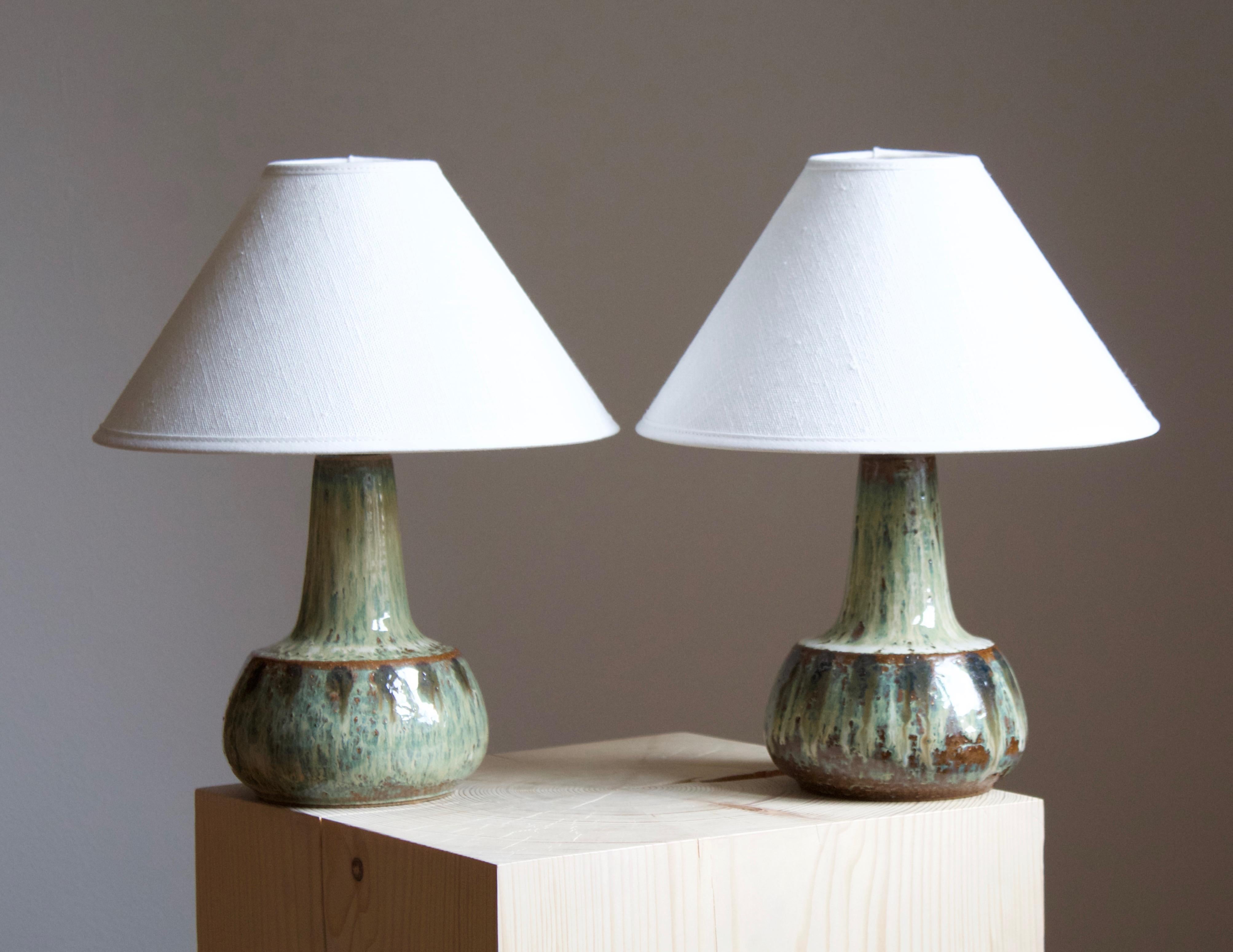 A pair of table lamps produced by Søholm Keramik, located on the island of Bornholm in Denmark. Features a highly artistic glazed and incised decor. 

Sold without lampshade. Stated dimensions exclude the lampshade. Height includes