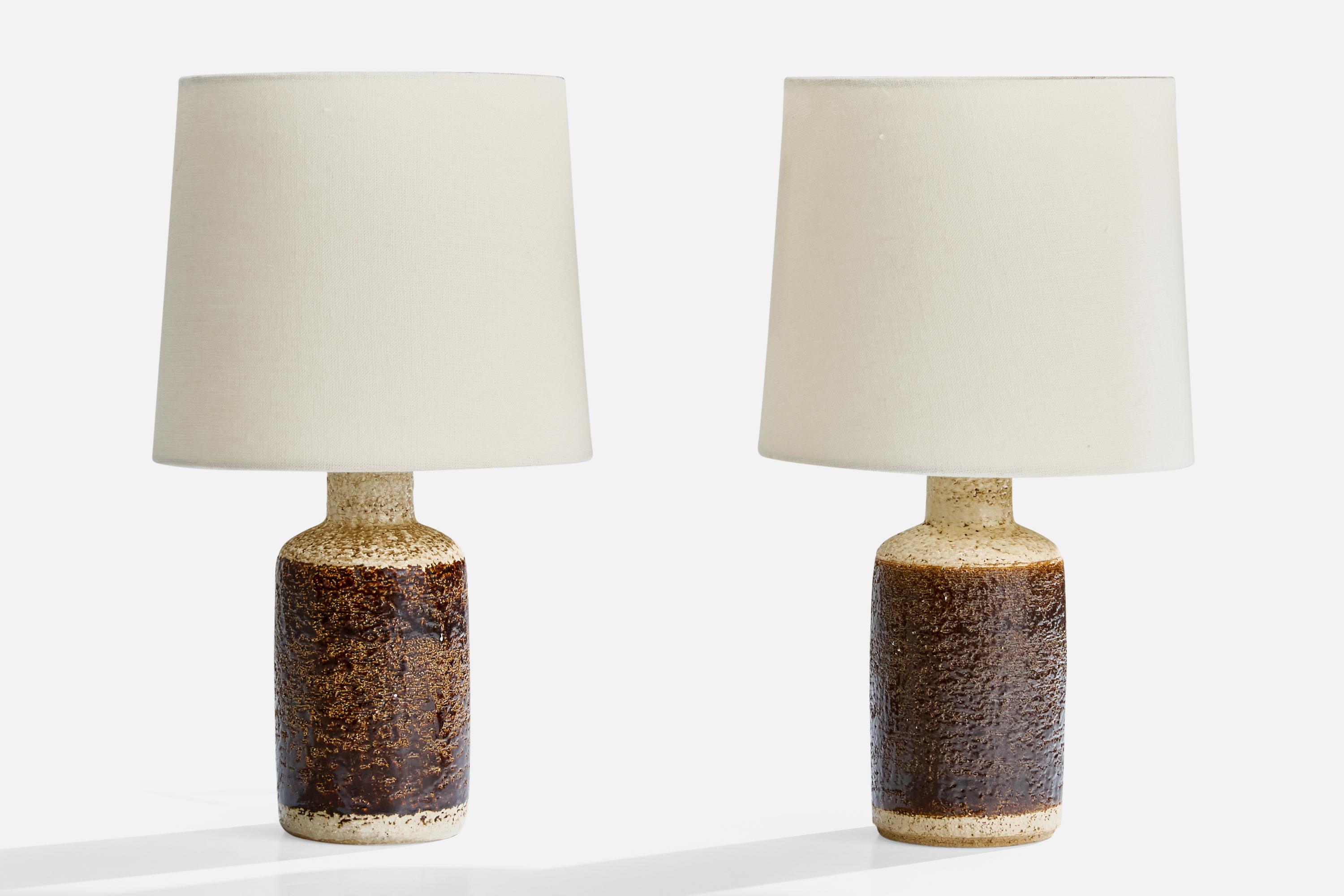 A pair of grey and brown-glazed stoneware table lamps designed and produced by Søholm Stentøj, Denmark, c. 1960s.

Dimensions of Shade (inches): 7” Top Diameter x 8” Bottom Diameter x 7” Height

Dimensions of Lamp with Shade (inches): 14.25” Height