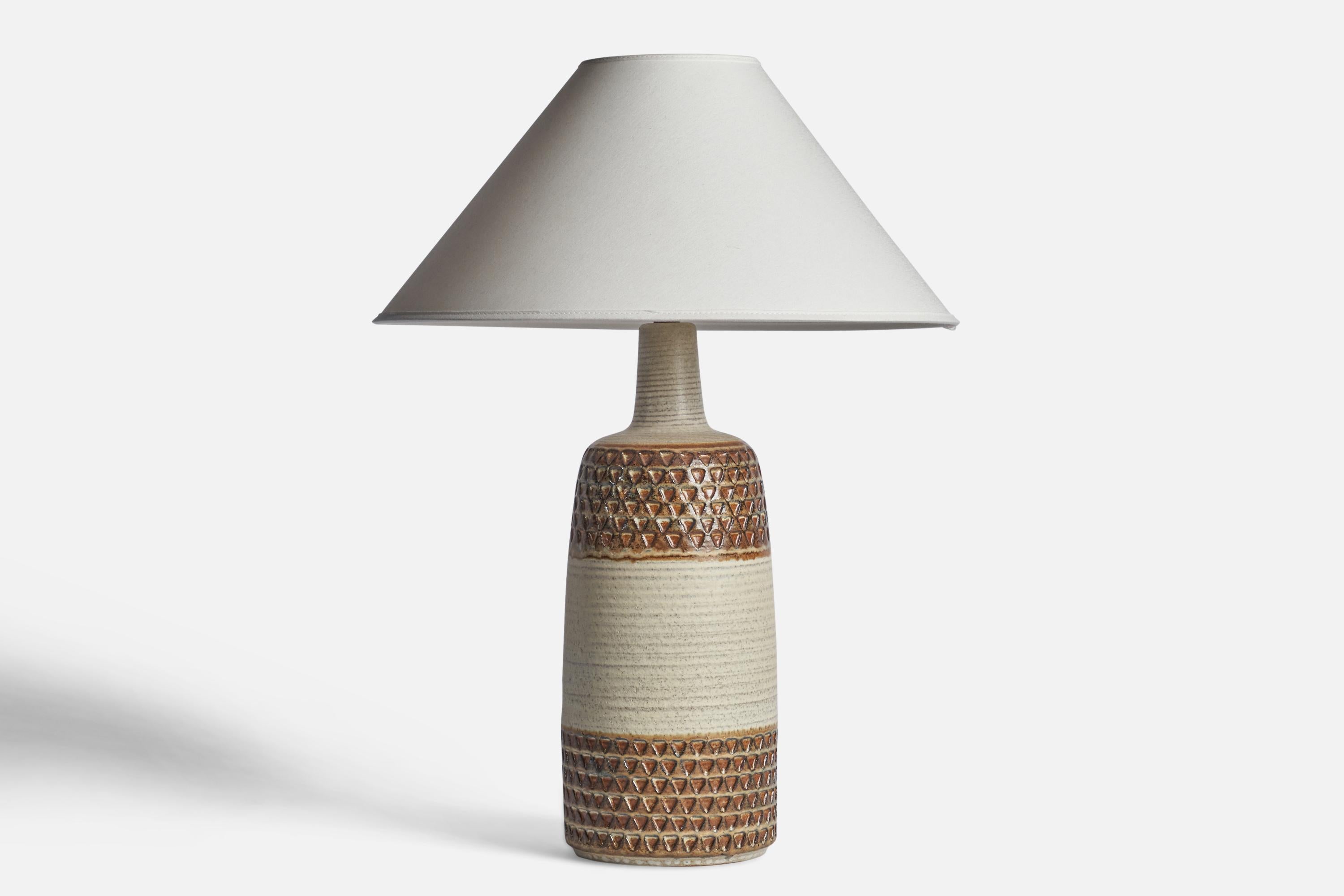 A brown and white-glazed stoneware table lamp designed and produced by Søholm Keramik, Bornholm, Denmark, 1960s.

Dimensions of Lamp (inches): 17” H x 6” Diameter
Dimensions of Shade (inches): 4.5” Top Diameter x 16” Bottom Diameter x 7.25”