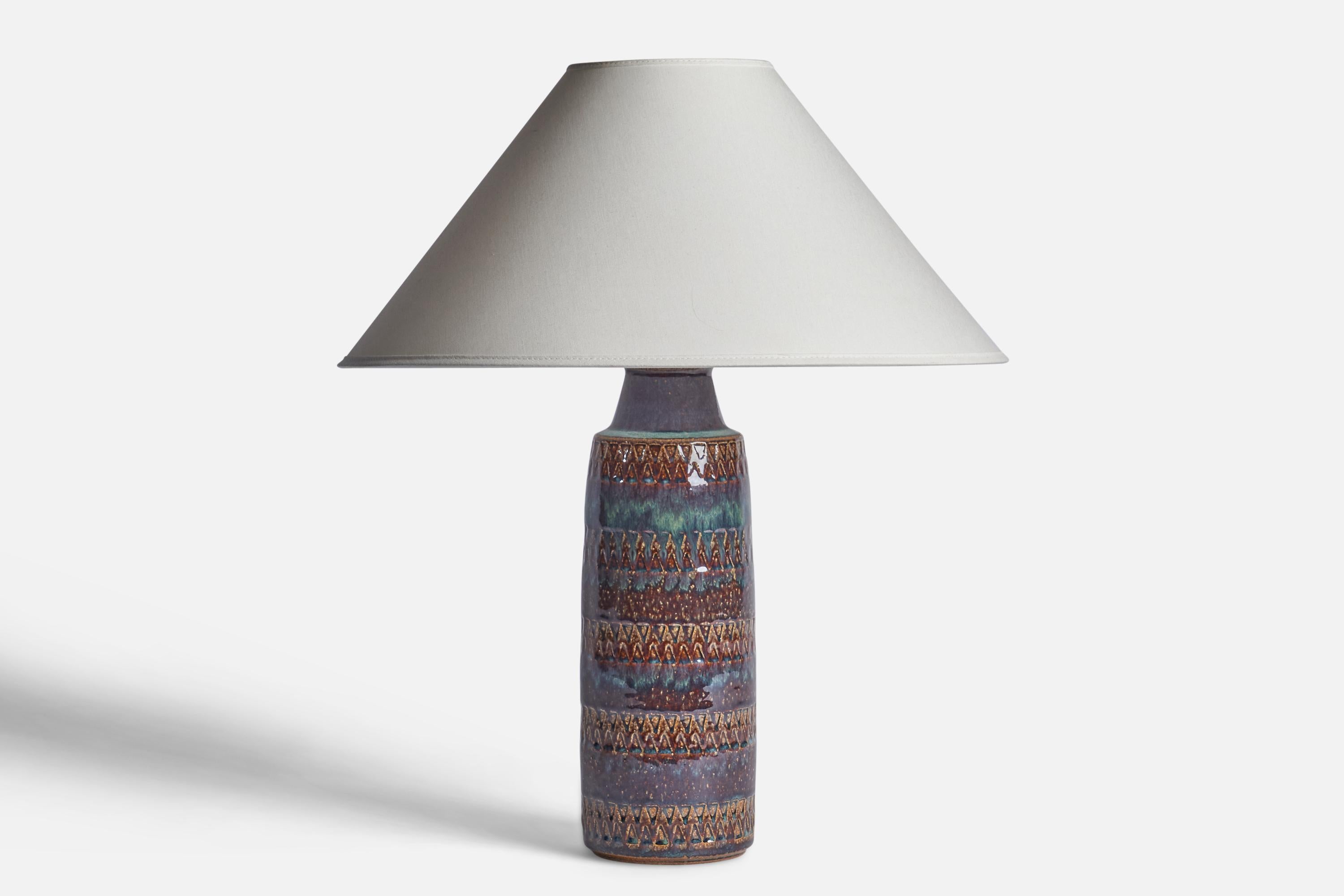 A blue and brown-glazed stoneware table lamp designed and produced by Søholm, Bornholm, Denmark, c. 1960s.

Dimensions of Lamp (inches): 15” H x 4” Diameter
Dimensions of Shade (inches): 4.5” Top Diameter x 16” Bottom Diameter x 7.25” H
Dimensions