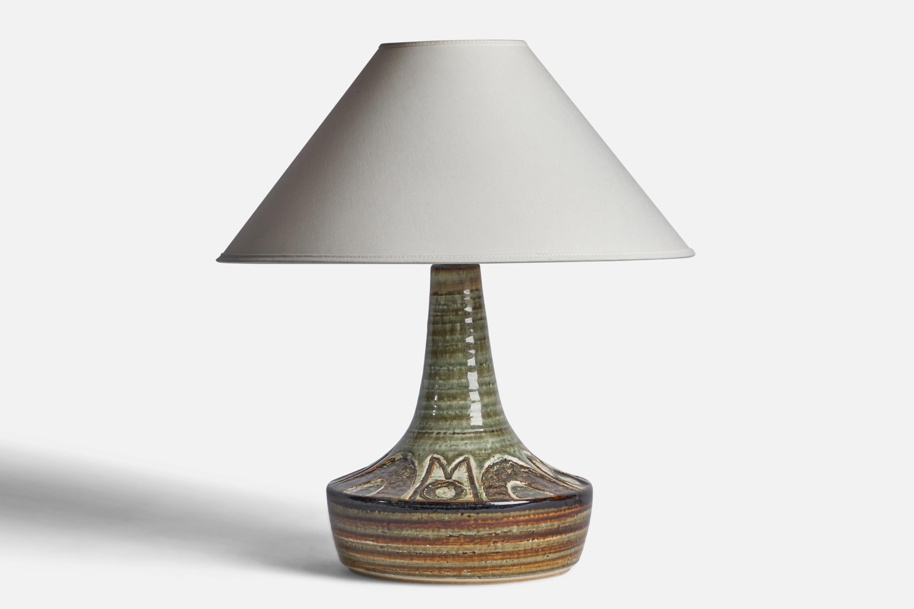 A green-glazed stoneware table lamp designed and produced by 
Søholm, Bornholm, Denmark, 1960s.

Dimensions of Lamp (inches): 13.35” H x 8.9” Diameter
Dimensions of Shade (inches): 4.5” Top Diameter x 16” Bottom Diameter x 7.15” H 
Dimensions of