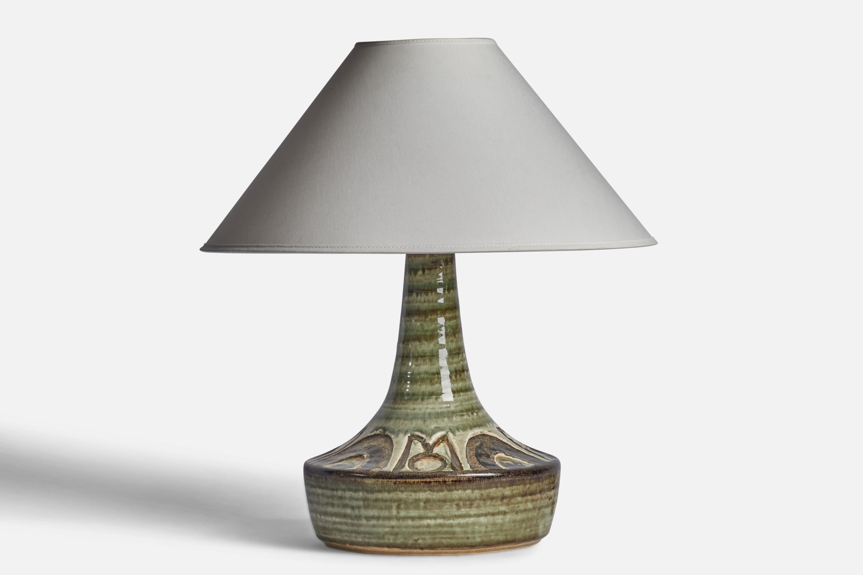 A green-glazed stoneware table lamp designed and produced in Denmark, 1960s.

Dimensions of Lamp (inches): 13.25” H x 9” Diameter
Dimensions of Shade (inches): 4.5” Top Diameter x 15.75” Bottom Diameter x 9” H
Dimensions of Lamp with Shade (inches):