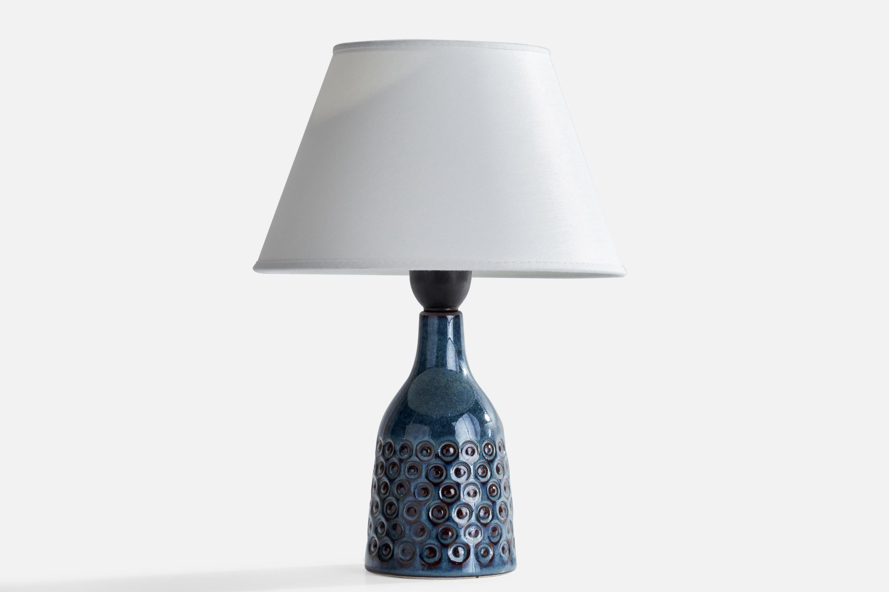 A blue-glazed stoneware table lamp designed and produced by Søholm, Bornholm, Denmark, c. 1960s.

Dimensions of Lamp (inches): 8.25”  H x 3.5”  Diameter
Dimensions of Shade (inches): 4.75” Top Diameter x 8.25”Bottom Diameter x 5.25” H
Dimensions of